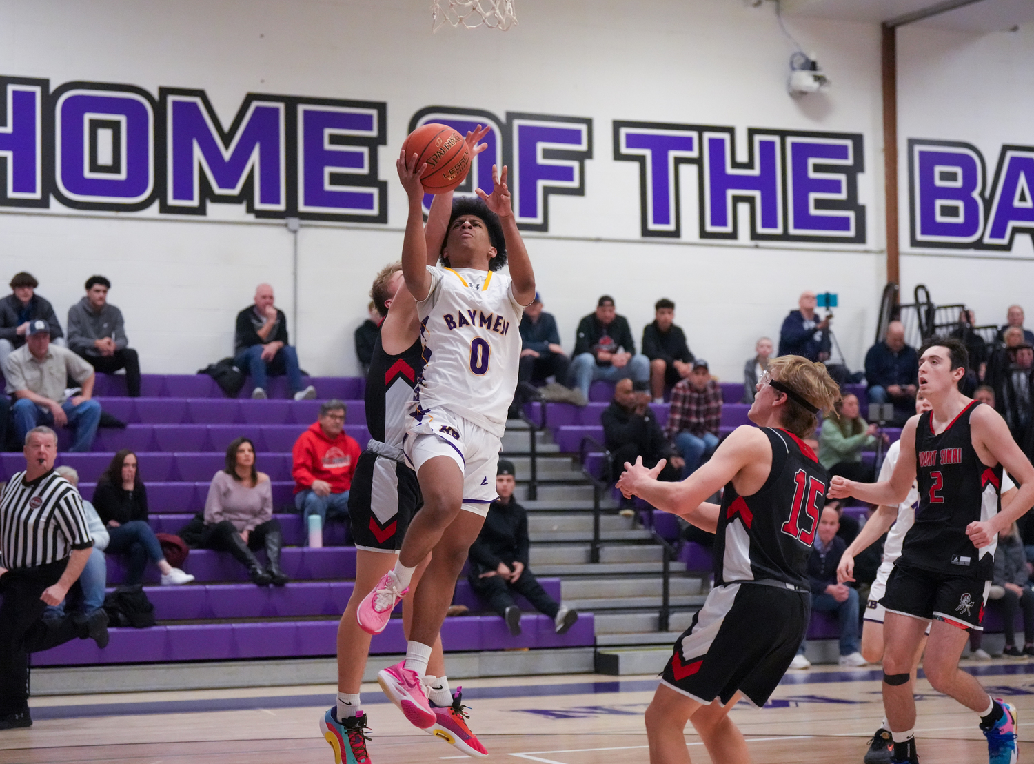 Hampton Bays senior Danny Wilson gets fouled as he's going up for a layup.   RON ESPOSITO