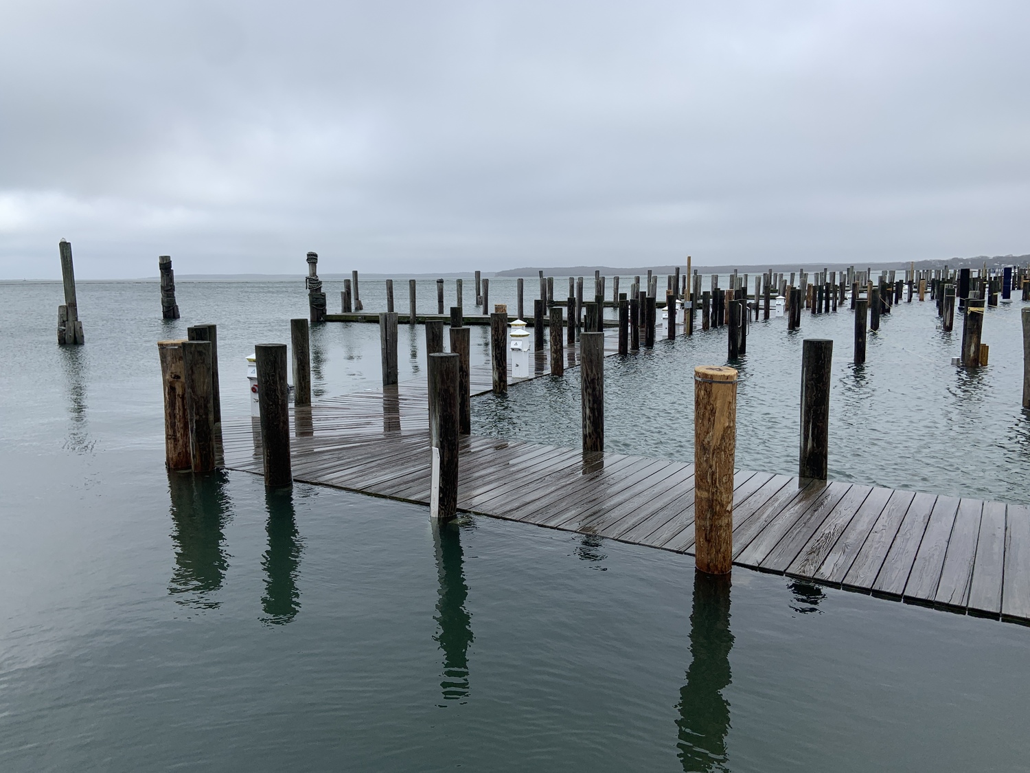 The water was level with docks at Waterfront Marina in Sag Harbor at high tide following Saturday's heavy rain and winds. STEPHEN J. KOTZ