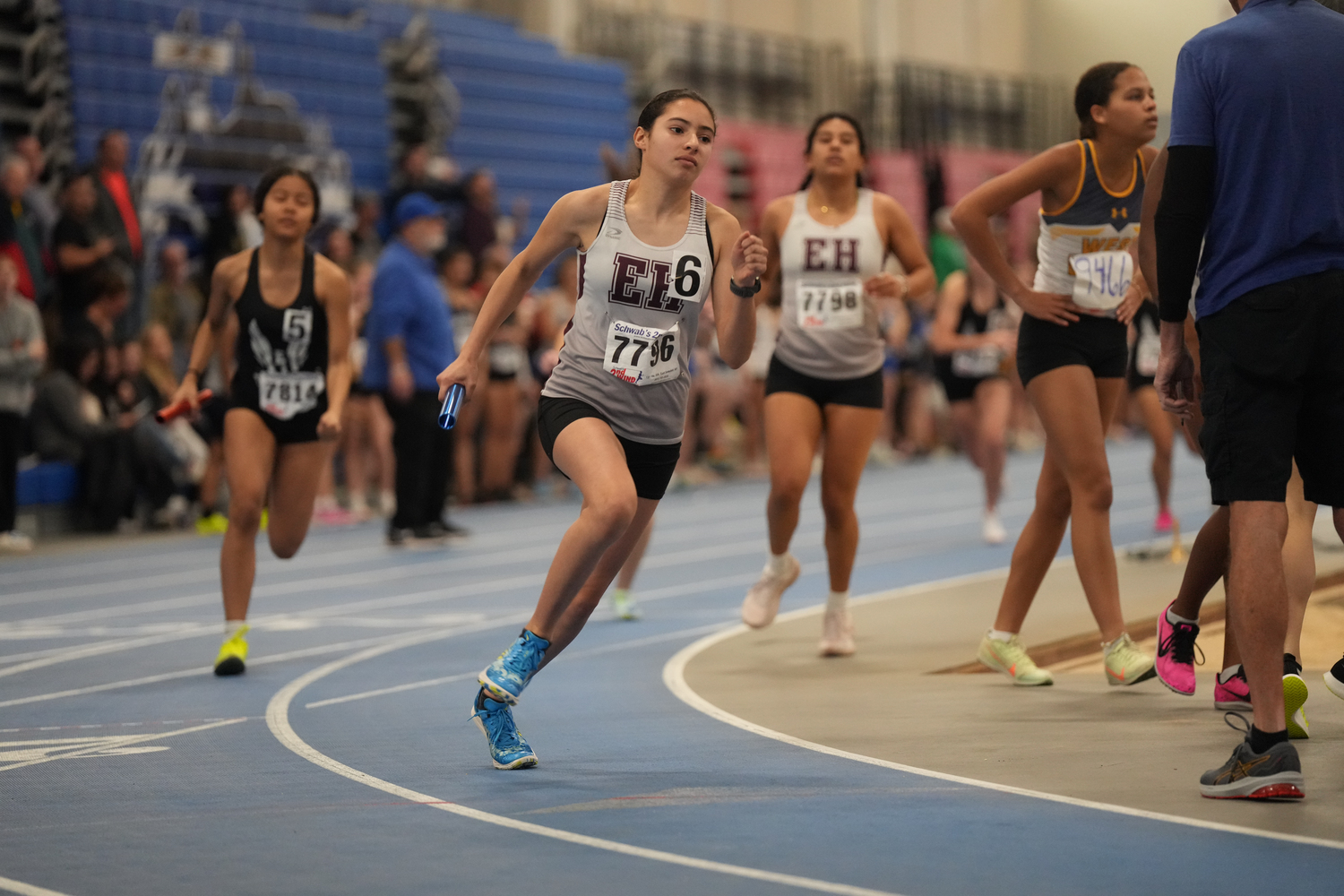 Laura Martinez sprints in the 4x200-meter relay after taking the baton from Ali Muñoz.   RON ESPOSITO