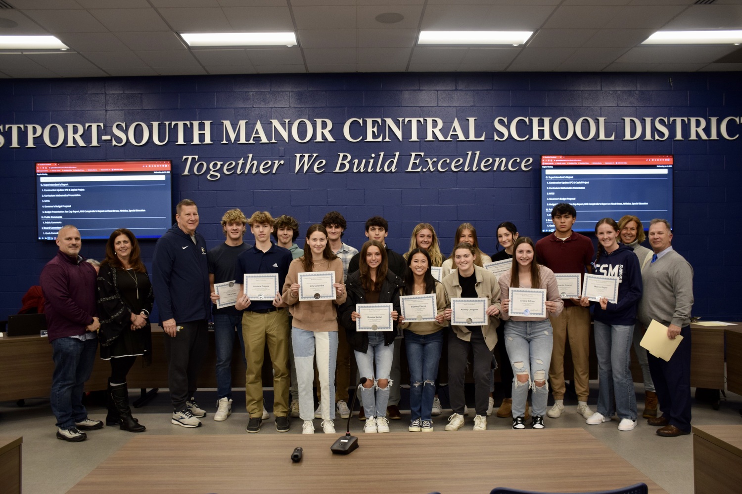 Eastport-South Manor Board of Education President James Governali, Vice President Cristina Costanza, volleyball coach Bill Kropp, (right) field hockey coach Anna Naughton
and Interim Director of Health, Physical Education and Athletics William Madsen are with fall athletes honored during the January 24 board meeting. COURTESY EASTPORT-SOUTH MANOR SCHOOL DISTRICT