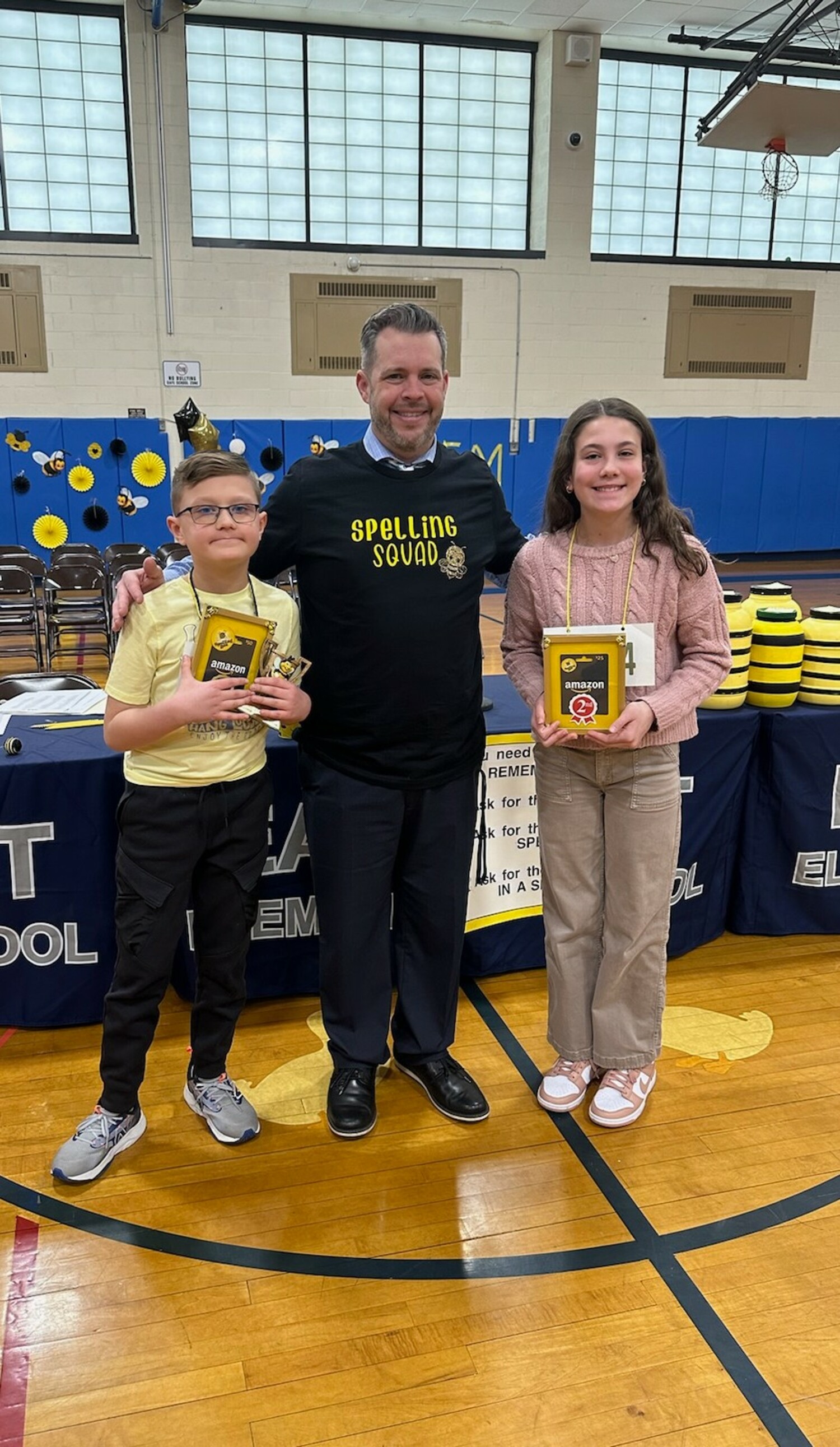 Eastport Elementary School Principal Thomas Fabian  with spelling bee winner Christian Keppeler and runner-up Liliana Cavalieri.