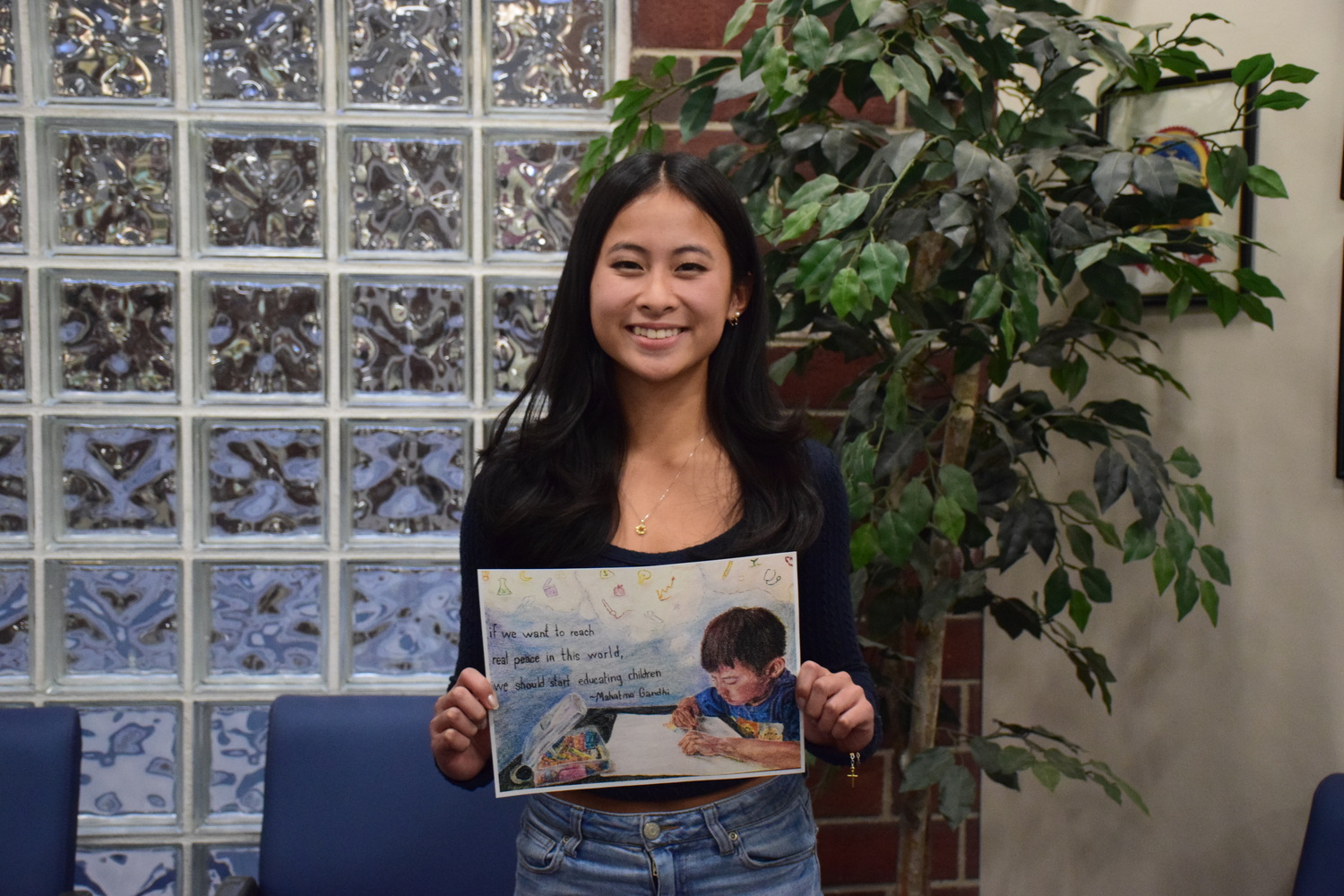 Eastport-South Manor Jr.-Sr. High School student Sydney Flores is pictured with her award-winning Shante Peace Poster Contest submission. COURTESY EASTPORT-SOUTH MANOR SCHOOL DISTRICT