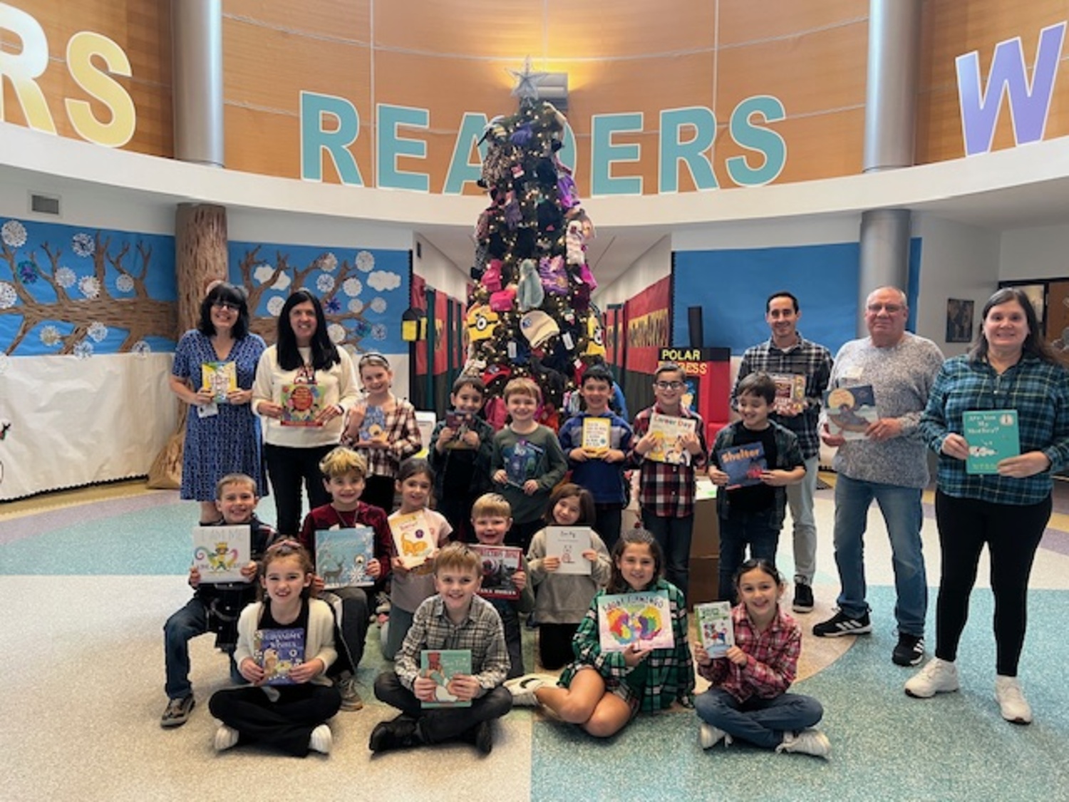 Tuttle Avenue Elementary School students collected books for the Rotary Club of Moriches, represented by, back left to right, Moriches Rotary President Deborah Volkmann-Brown, Tuttle Avenue Elementary School second grade teacher Elise Allen, second grade teacher Tim Minerva, Moriches Rotary representative Tom Chieffo and Tuttle Avenue teacher assistant Jill Knoerser.
COURTESY EASTPORT-SOUTH MANOR SCHOOL DISTRICT
