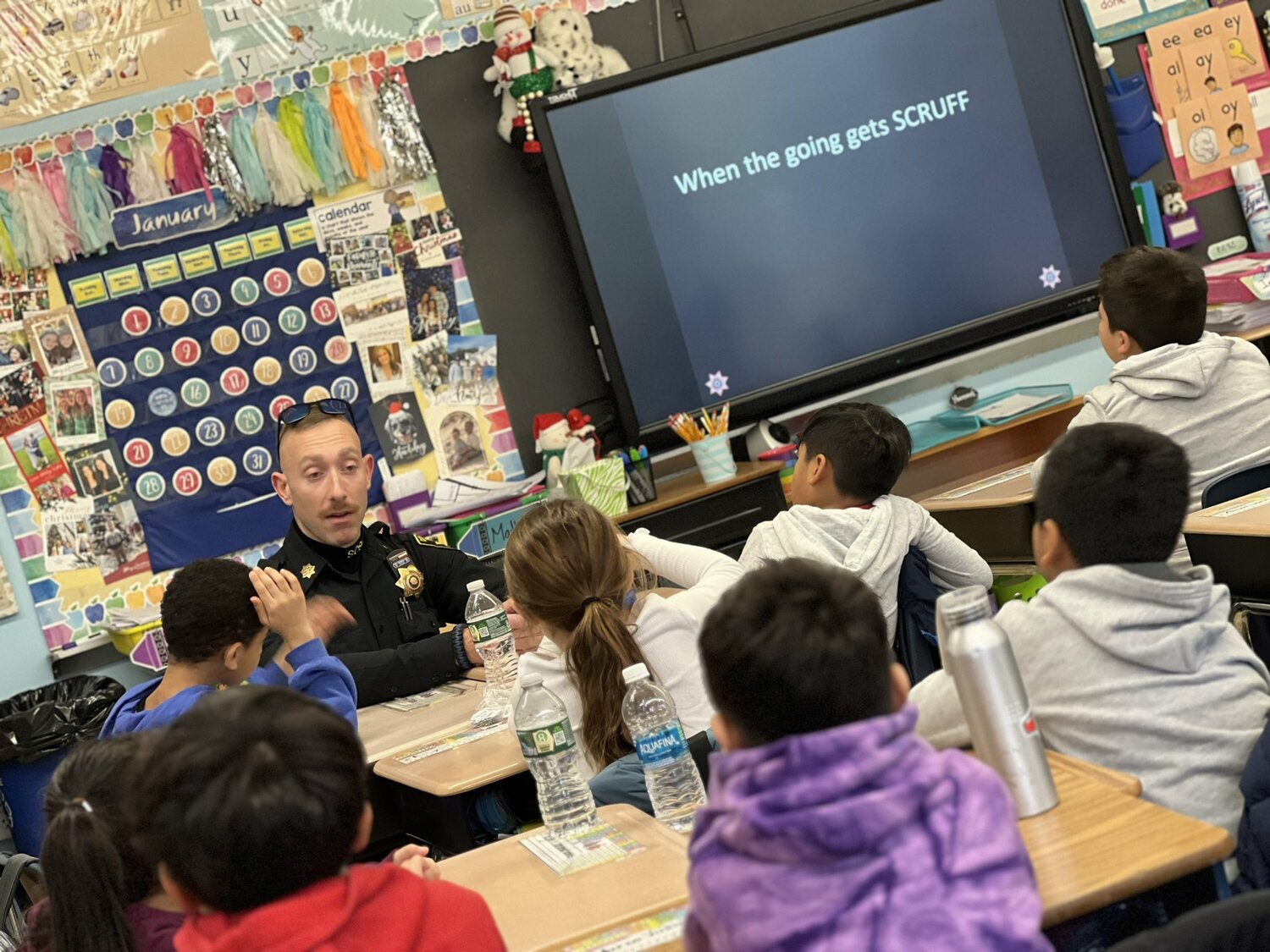 As part of the McGruff safety program, Hampton Bays Elementary School
second graders spent time with Deputy Dylan Hever learning about antibullying and the
importance of “stop, talk and walk.” The method encourages students to first ask a bully to stop, to talk to an adult about the problem, and, if the situation doesn’t improve, to walk away. COURTESY HAMPTON BAYS SCHOOL DISTRICT