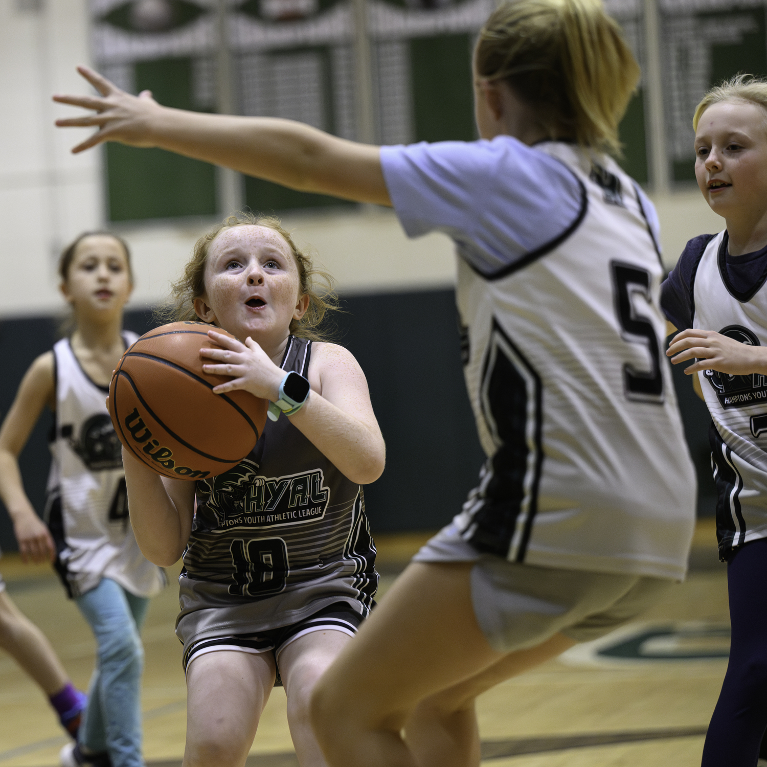 Local Hamptons Youth Athletic League basketball players faced off during halftime of Westhampton Beach's girls basketball game Friday, January 19. MARIANNE BARNETT