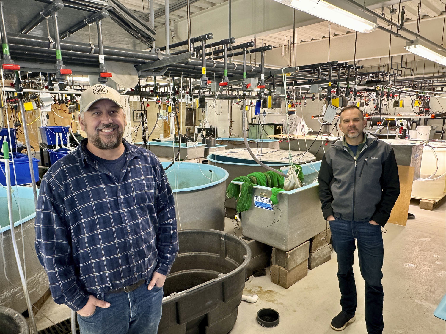 Stony Brook Marine Science Center Manager Chris Paparo and Professor Christopher Gobler, Ph.D., at the marine center. MICHAEL WRIGHT