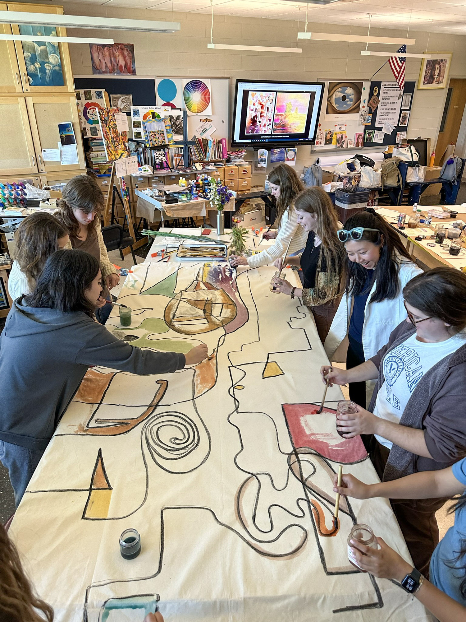 Artist Beau Bree Rhee, right center, works with a group of East Hampton High School students on their piece for 