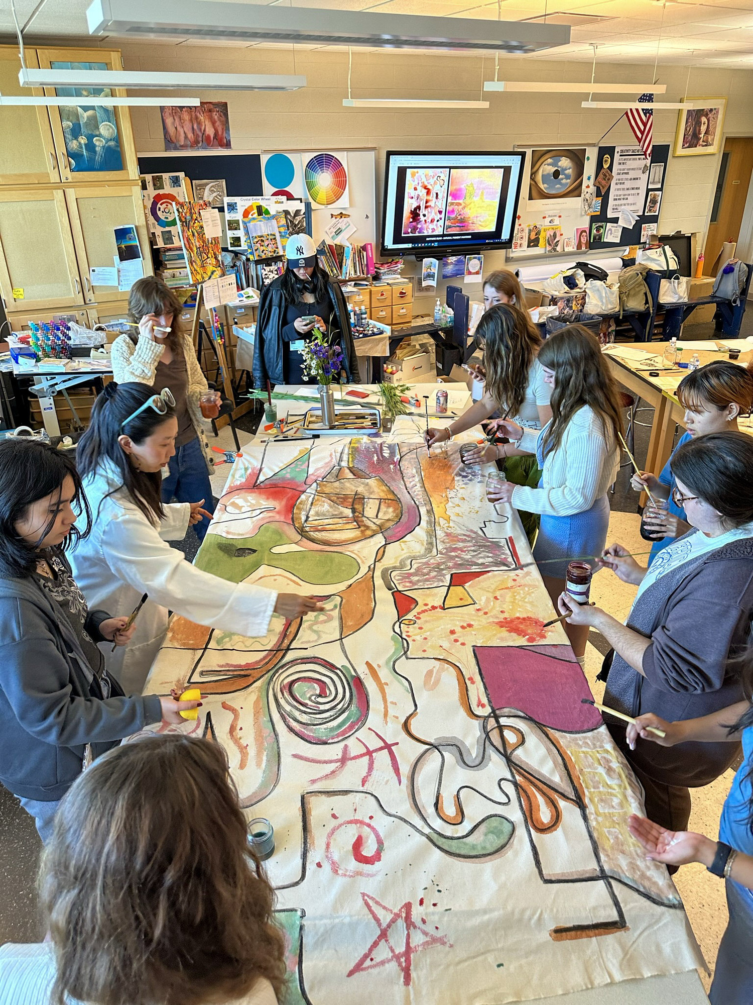 Artist Beau Bree Rhee, left center, works with a group of East Hampton High School students on their piece for 