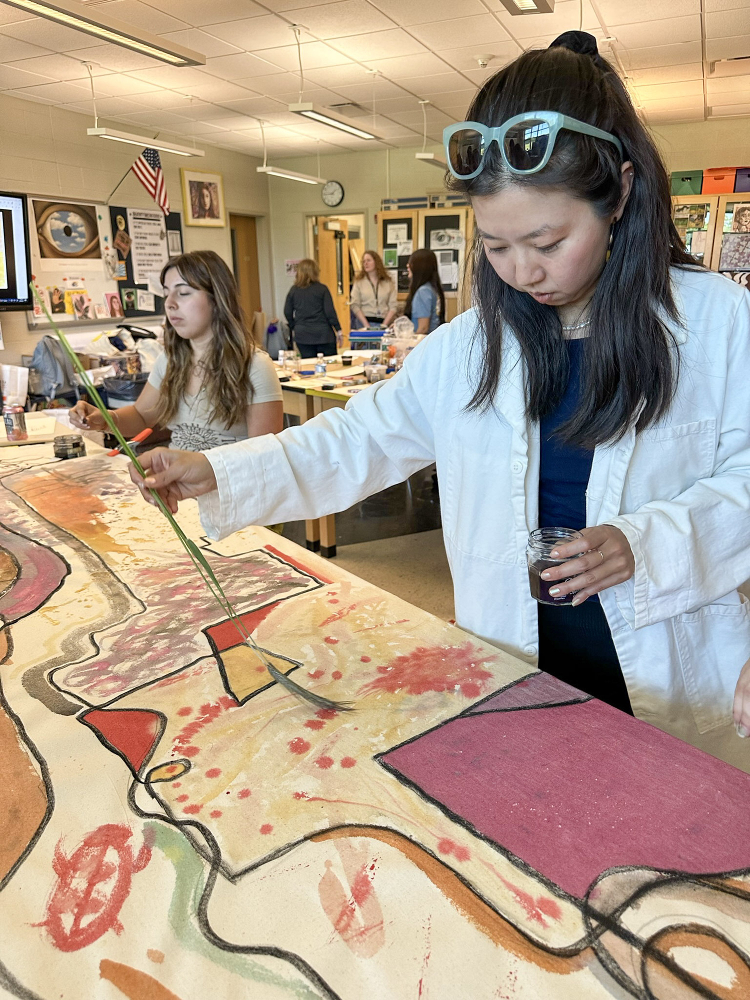 Artist Beau Bree Rhee works with a group of East Hampton High School students on their piece for 