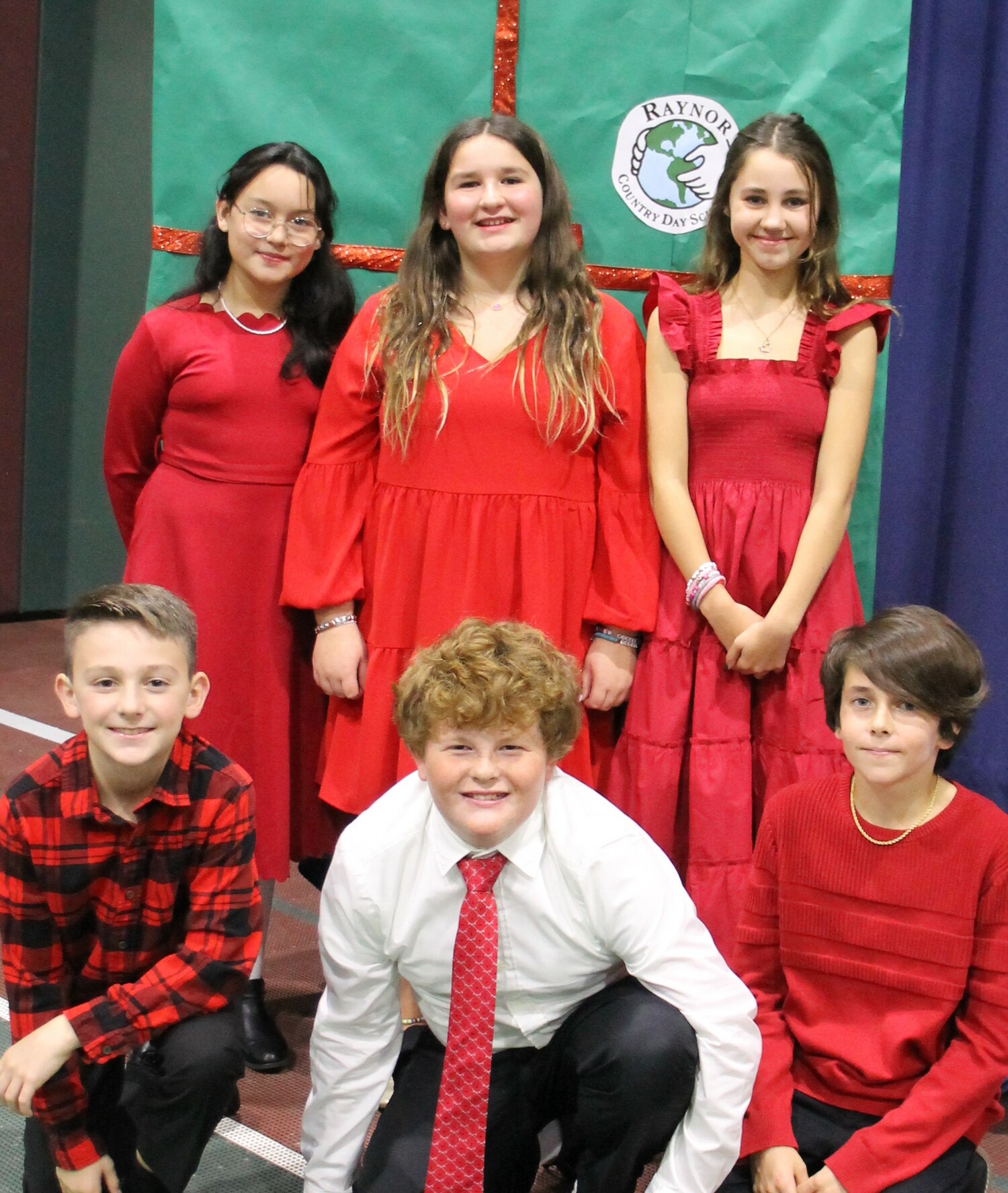 Raynor Country Day School students and staff hosted a Salvation Army Red Kettle Caroling event.  Individuals donated $5 to wear red in lieu of their daily uniform.  Additionally, the students headed outdoors to carol holiday songs for friends, family, and local residents of the community.  Each class took an opportunity to spread goodwill and holiday cheer.  COURTESY RAYNOR COUNTRY DAY SCHOOL