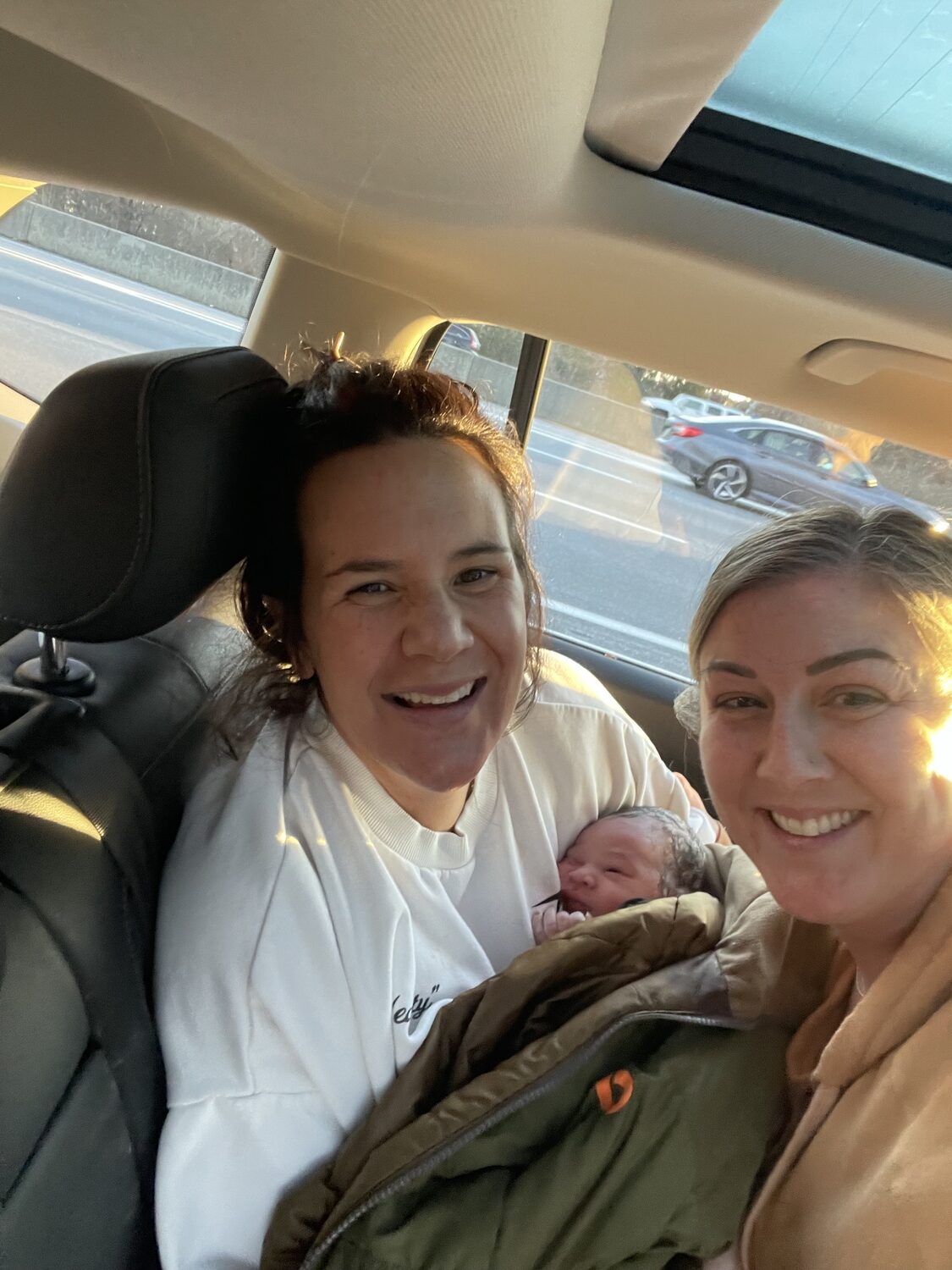 Ashley Bard with her doula, Corrin Abbatiello. Abbatiello had been following behind Bard and her husband in her car, and pulled over and delivered the baby while Ashley was in the back of the car.