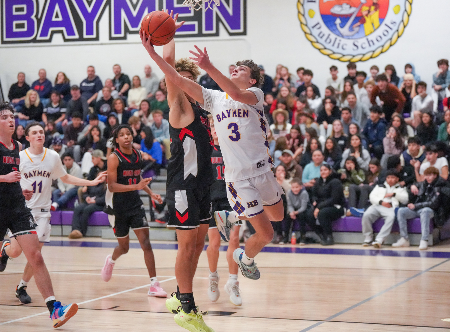 Senior Bayman James Powers tries to go up and under to score.   RON ESPOSITO