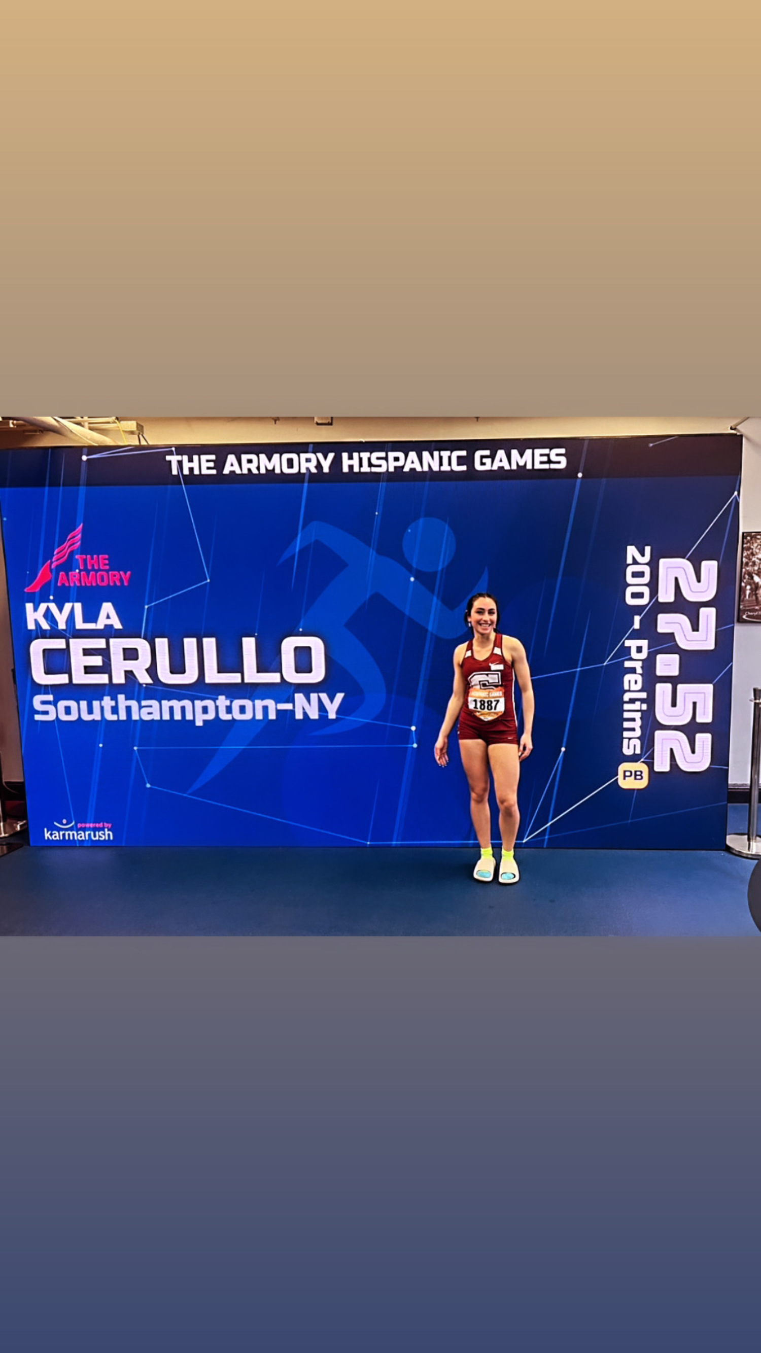 Kyla Cerullo stands in front of the scoreboard that has her new school record time in the 200-meter dash on it.    AMY CERULLO