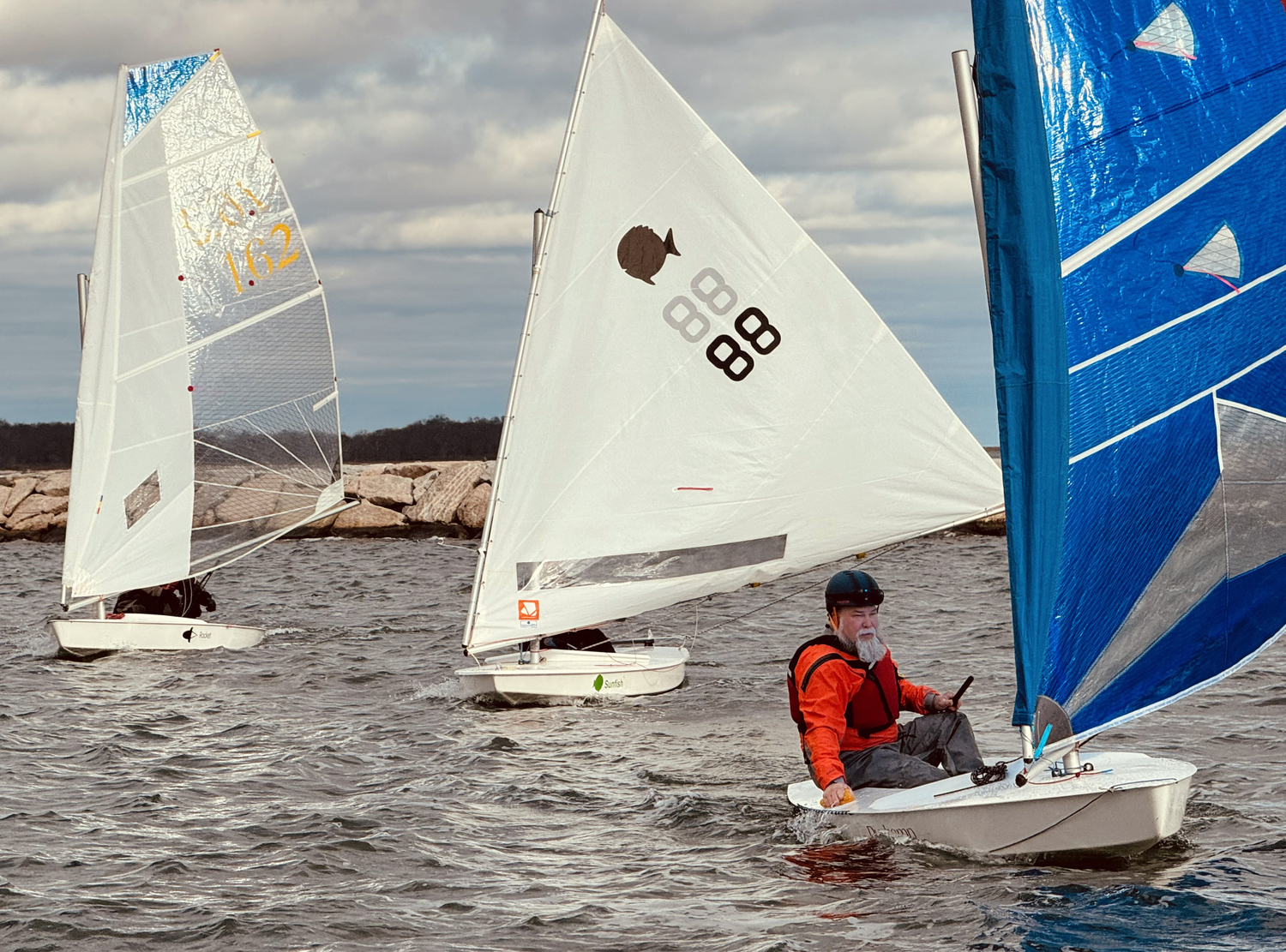 Broad-reaching in perfect form are rocket skipper Nick Gazzolo, the Breakwater Yacht Club’s newly elected commodore, Joan Butler sailing a class-legal sunfish and Marty Knob out in front.   MICHAEL MELLA