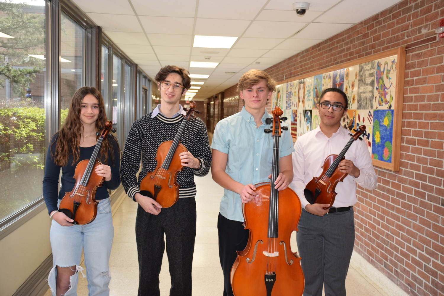 Four Southampton High School students --Julia
Vail, Julian Misut, Lucas Bencardino and Casey Cartagena -- recently represented their school as top string musicians at the Long Island String Festival Association Suffolk Secondary Festival at Hauppauge High School. COURTESY SOUTHAMPTON SCHOOL DISTRICT