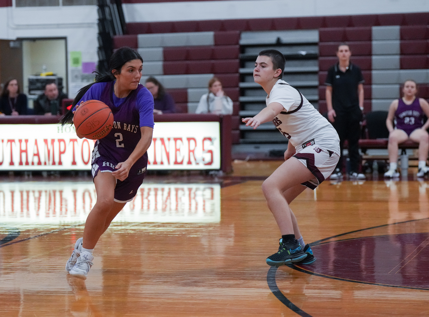 Tania Quiros drives on Riley Moredock.   RON ESPOSITO/SOUTHAMPTON SCHOOL DSITRICT