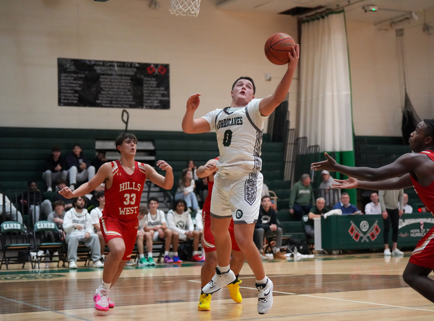 Senior power forward Andrew Mensch reaches for the ball in a game against Half Hollow Hills West January 11. RON ESPOSITO