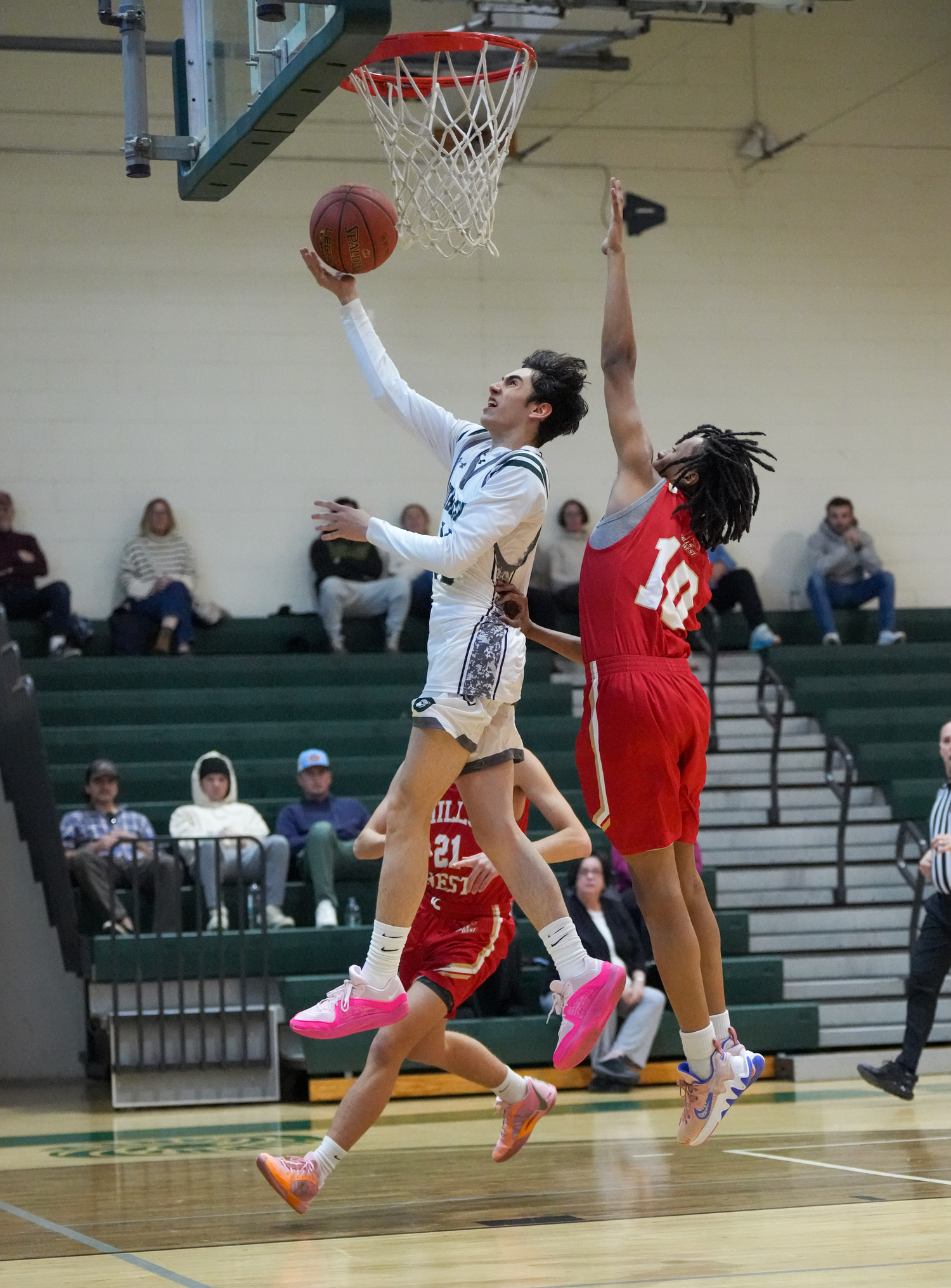 Junior guard Dante Quinones reaches for the rim in a game against Half Hollow Hills West January 11. RON ESPOSITO