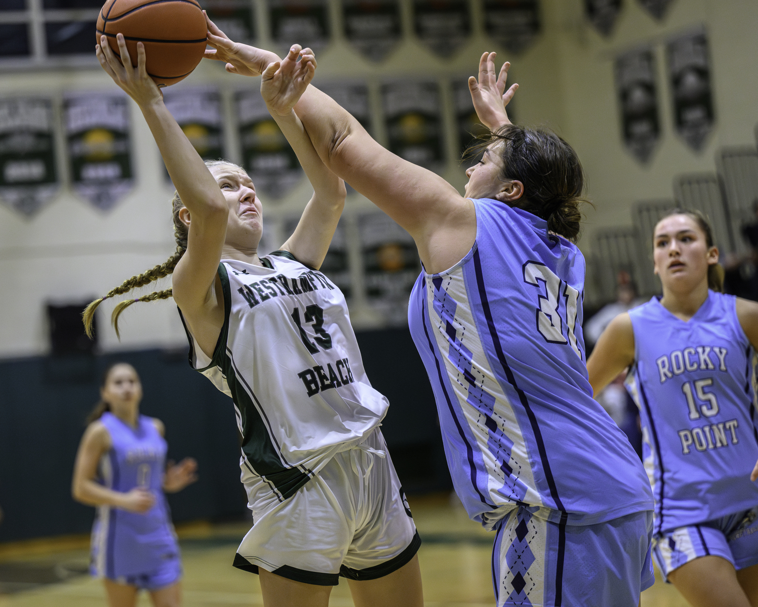 Freshman guard Kate Sweet shoots through a block attempt. MARIANNE BARNETT