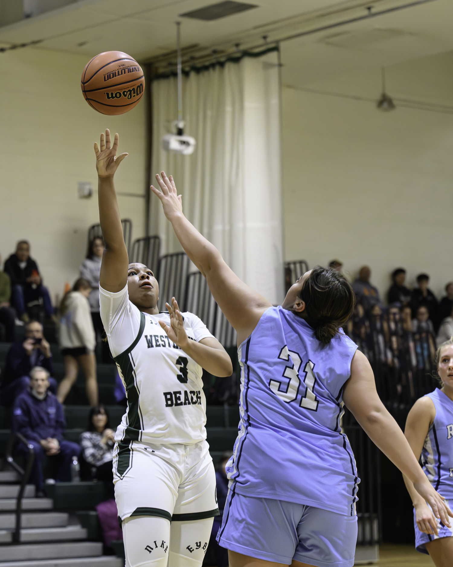 Sophomore point guard Sandra Clarke shoots over a defender. MARIANNE BARNETT