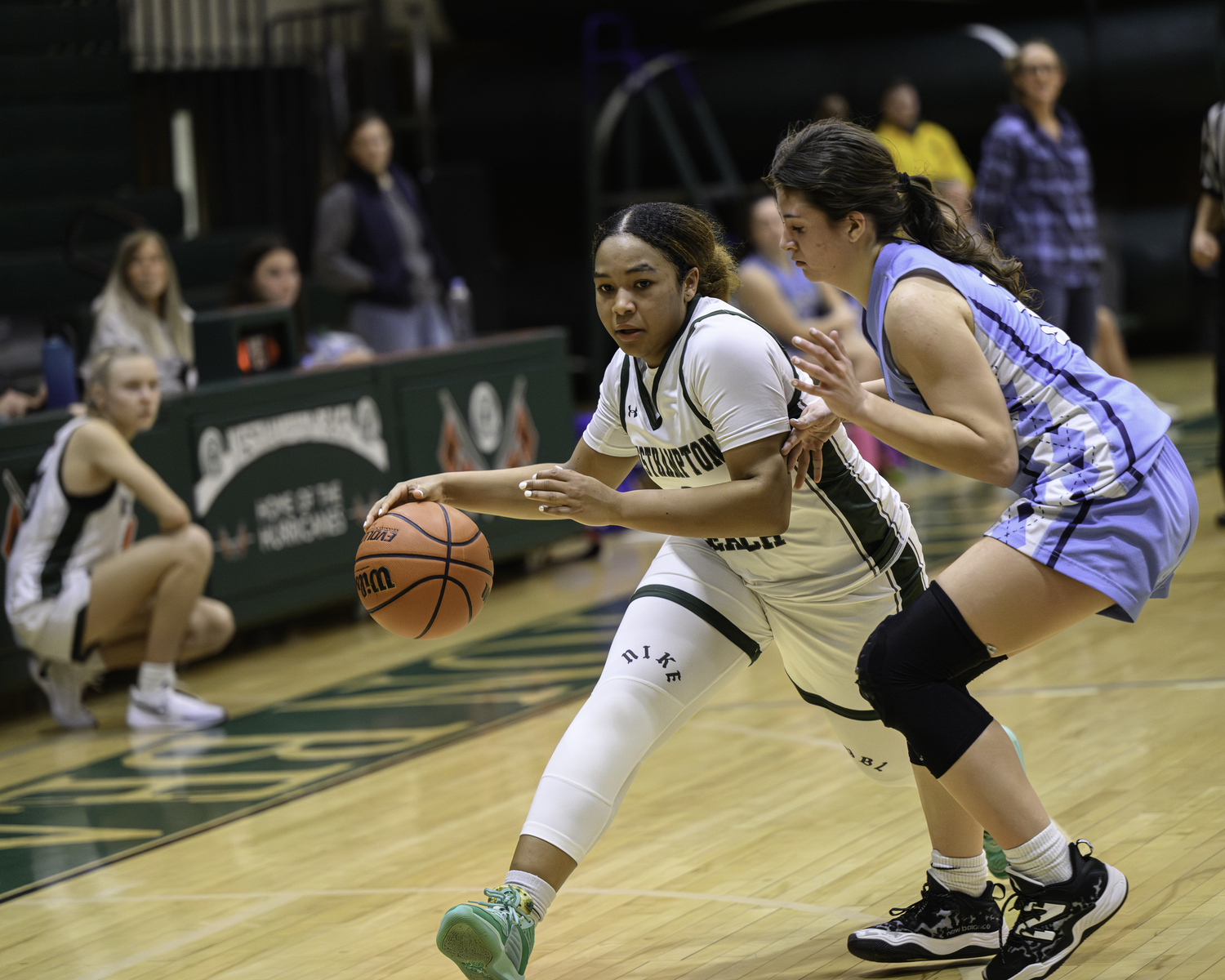 Sophomore point guard Sandra Clarke carries the ball around a Rocky Point defender. MARIANNE BARNETT
