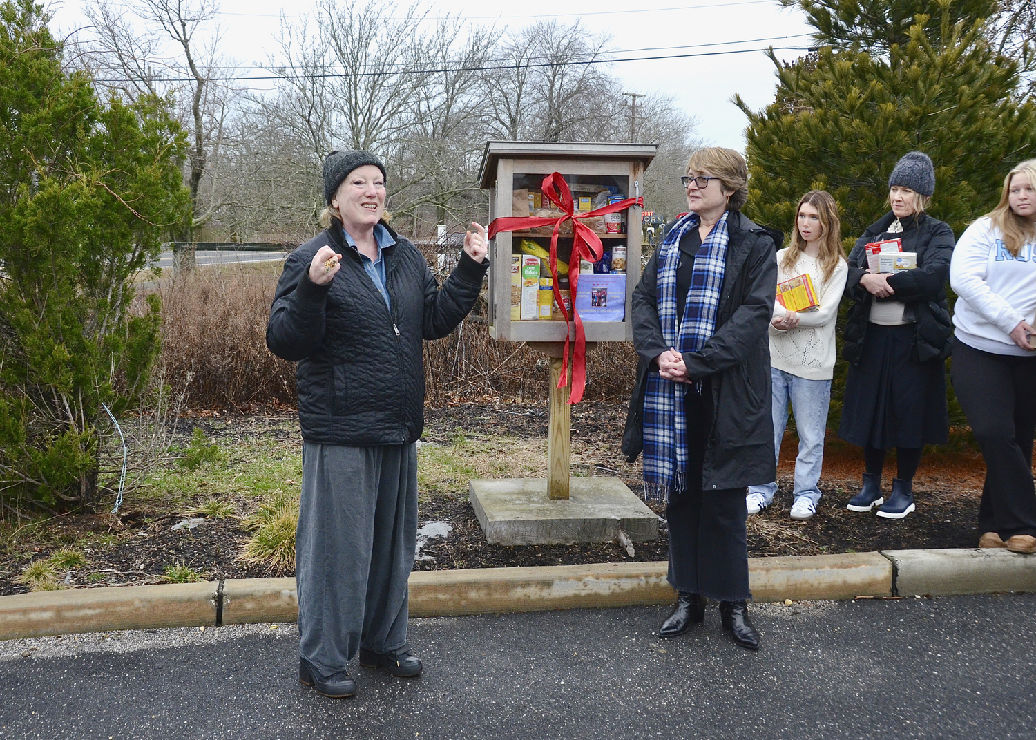 Kate Mueth and  East Hampton Town Supervisor Kathee Burke-Gonzalez at the ribbon-cutting and rededication of the little, free food pantry on January 25. The little, free pantry has move from its previous location at the Sunshine Shop in Amagansett to its new home at the Gansett Meadow housing community in Amagansett.    KYRIL BROMLEY