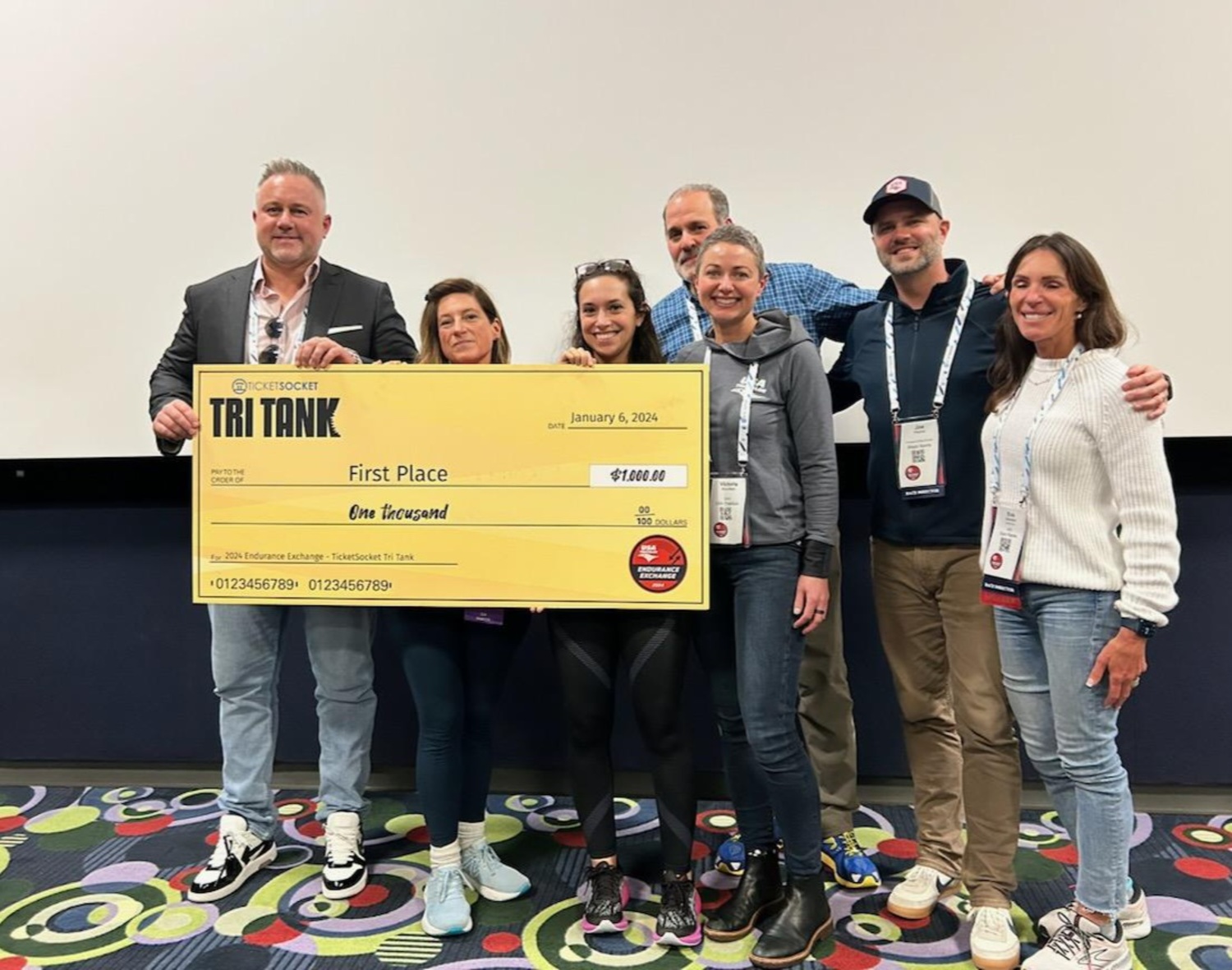Kai Blache from Ticketsocket, Theresa Roden and Samantha Rothberg with i-tri,  Victoria Brumfield, CEO of USA Triathlon, and additional members of the USA Triathlon team, after i-tri's pitch took the top prize at the conference. COURTESY I-TRI