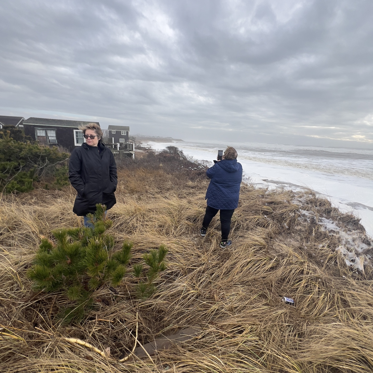 Supervisor Kathee Burke-Gonzalez and Councilwoman Cate Rogers survey the conditions at Ditch Plains during the second of three severe storms over the last month. DOUG KUNTZ