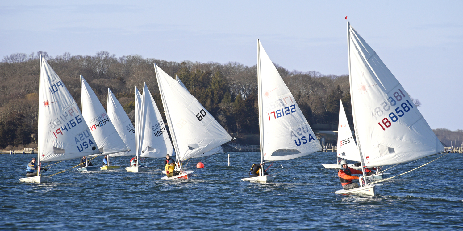 A majority of the fleet enjoying a delightful downwind leg to the finish line, sandwiched between Rachel Beardsley, left, and former BYC commodore Bud Rogers.  MICHAEL MELLA