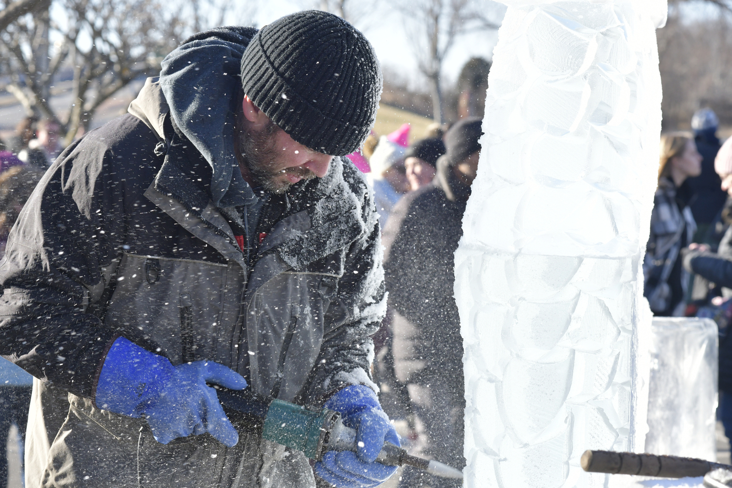 Richard Daly works on an ice sculpture on Long Wharf on Saturday.