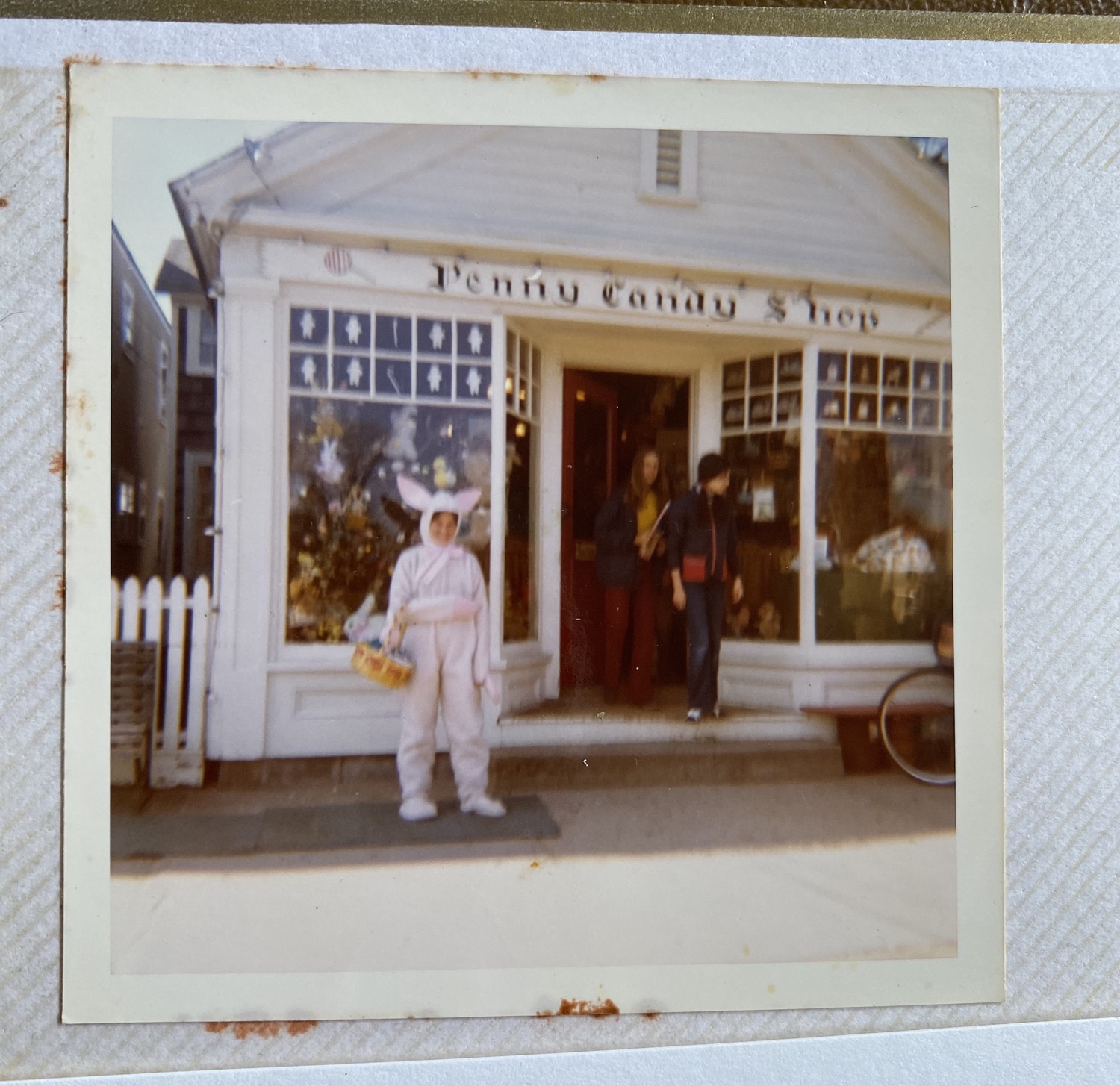 Eileen Noonan as a teenager, donning a bunny suit in front of the Penny Candy Shop in Water Mill, flags down passersby to wish them a happy Easter. COURTESY EILEEN NOONAN