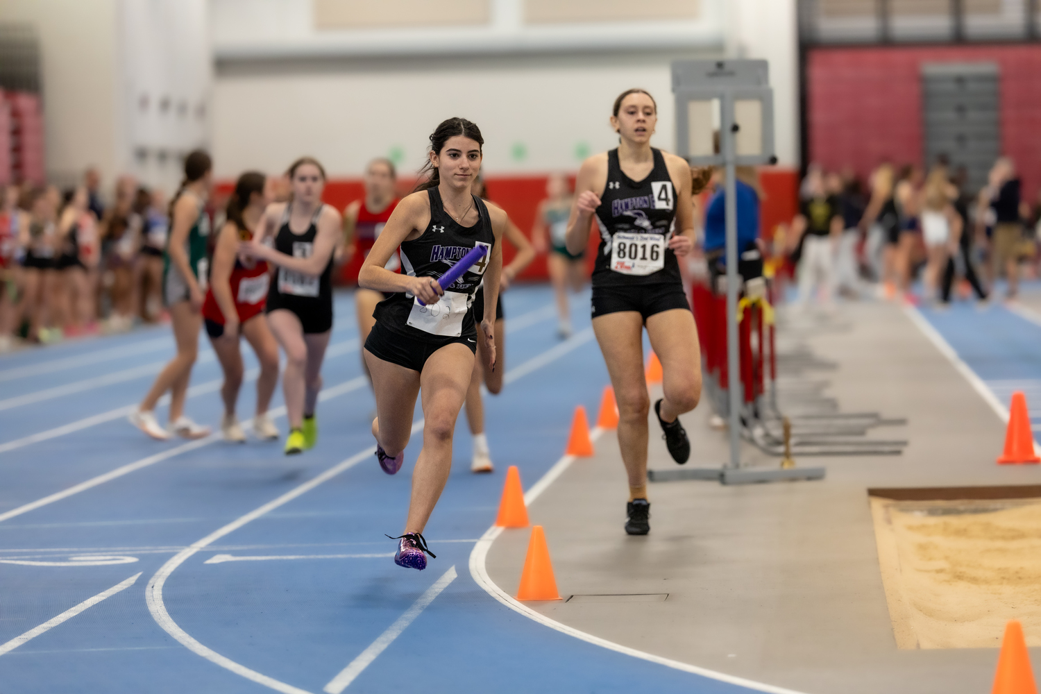 Izzy Ospitale takes off after taking the baton from Leah Fassino in the 4x200-meter relay.   RON ESPOSITO