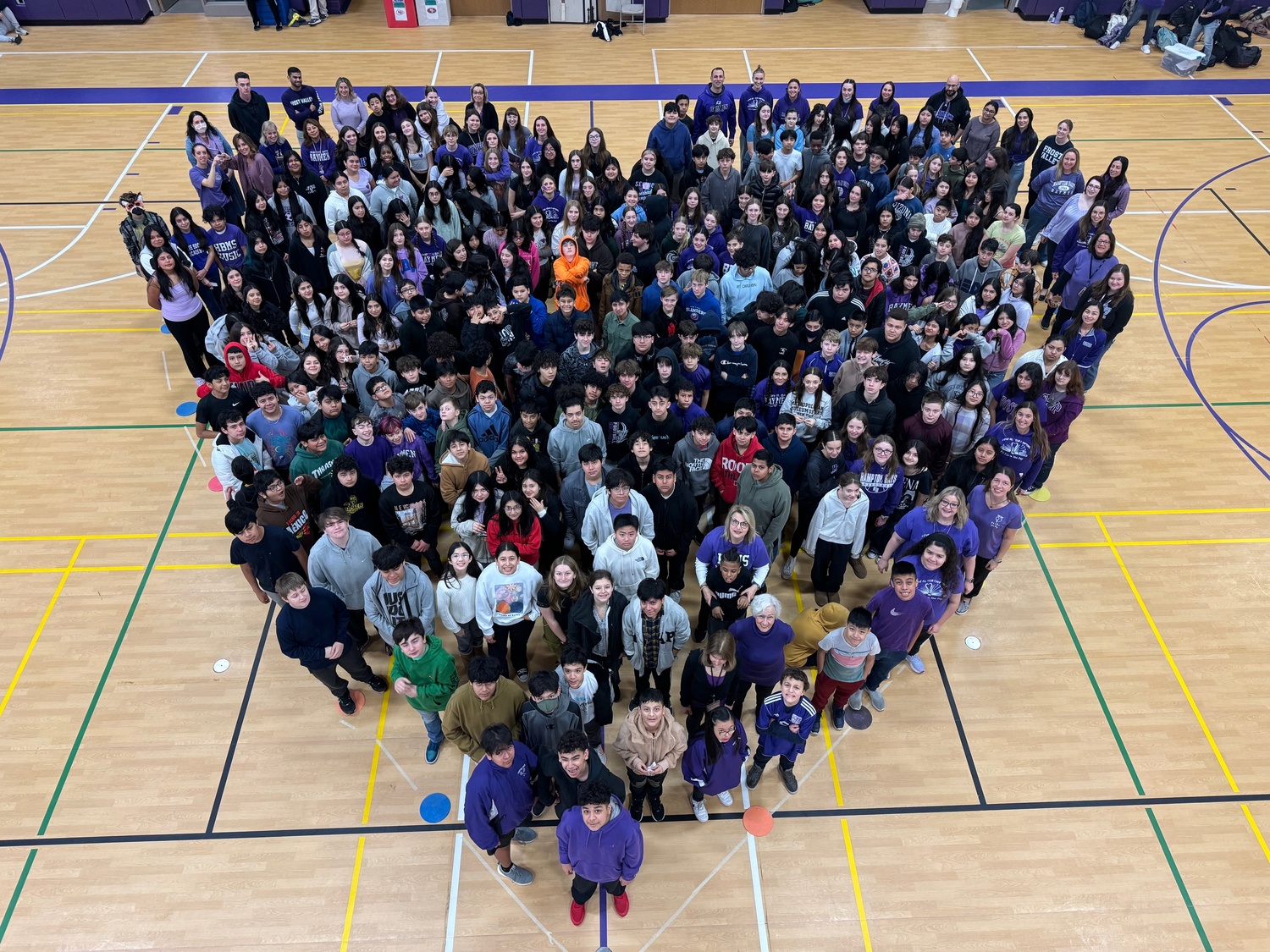 Hampton Bays Middle School students celebrated P.S. I Love You Day on Feb. 9 to raise awareness about bullying and suicide while promoting kindness. The students embraced the theme by showing kindness to their peers. They wrote positive messages on Post-it notes, created displays in their hallways and wore purple. They also formed a large heart for a group photo in the school’s gym. COURTESY HAMPTON BAYS SCHOOL DISTRICT