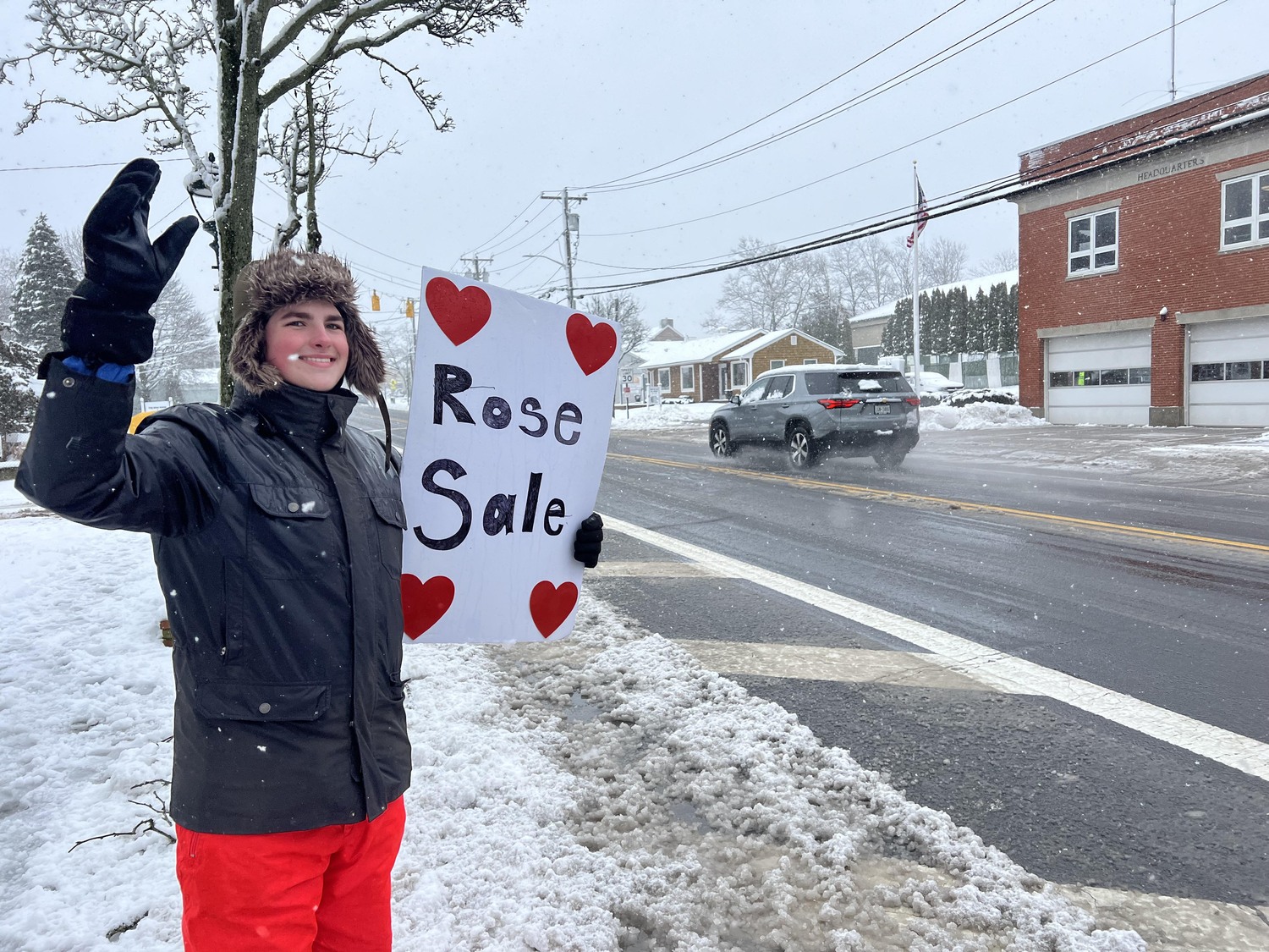 Despite the inclement weather Hampton Bays Boy Scout Troop 483 was busy selling rose bouquets  for Valentine's Day on Tuesday. Chris Morro tries to entice shoppers.