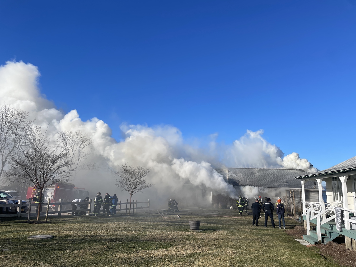 Montauk Fire Department firefighters battled a fire that badly damaged a waterfront cottage on East Lake Drive on Monday morning. Nobody was home when the fire broke out. DOUG KUNTZ