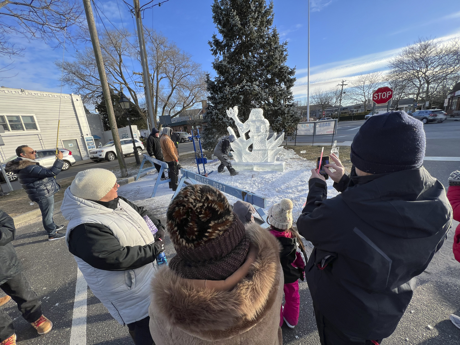 Ice carver Rich Daly works on a sculpture of Neptune on Long Wharf at HarborFrost 2023.   DANA SHAW