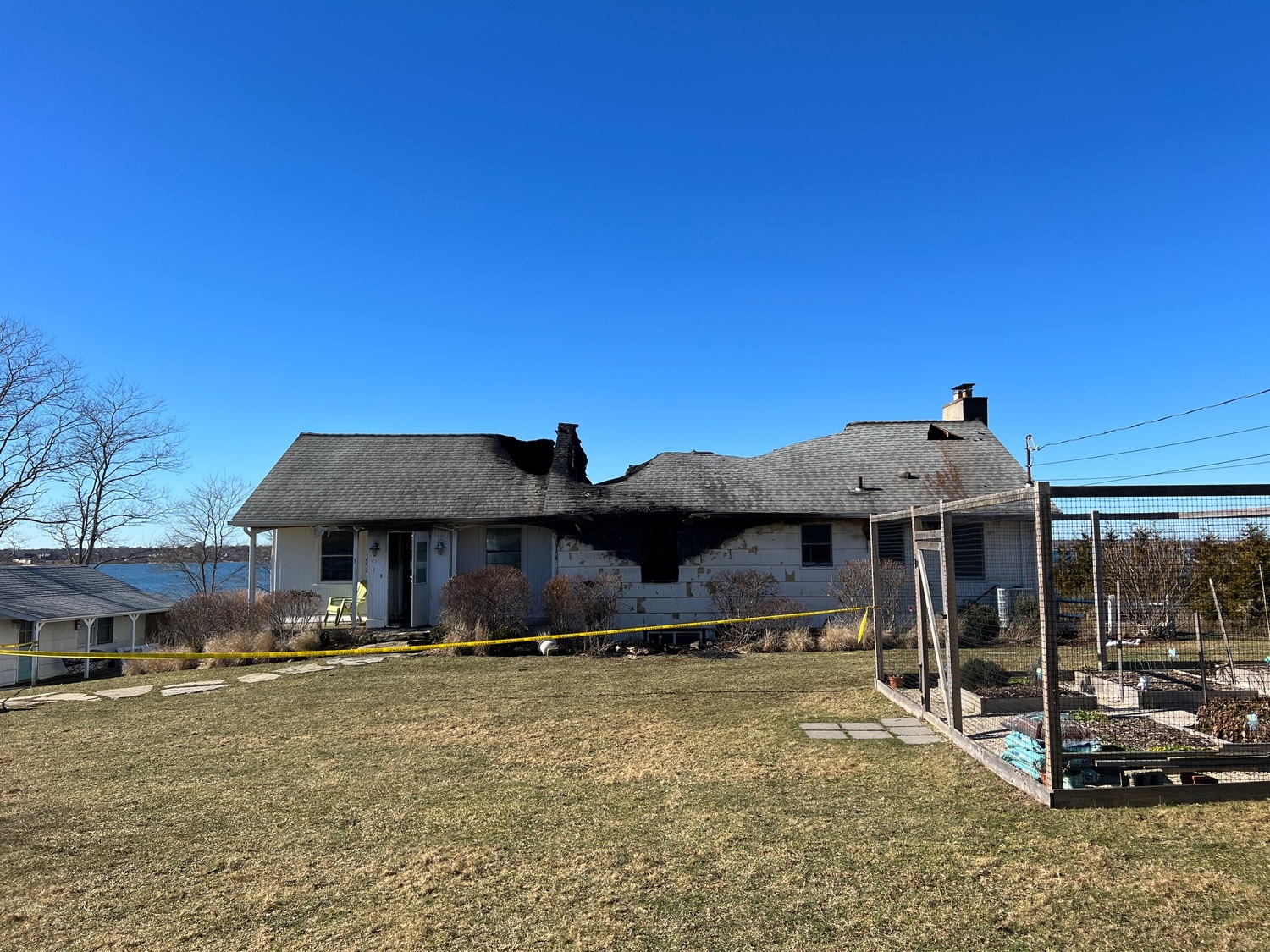Montauk Fire Department firefighters battled a fire that badly damaged a waterfront cottage on East Lake Drive on Monday morning. Nobody was home when the fire broke out. DOUG KUNTZ
