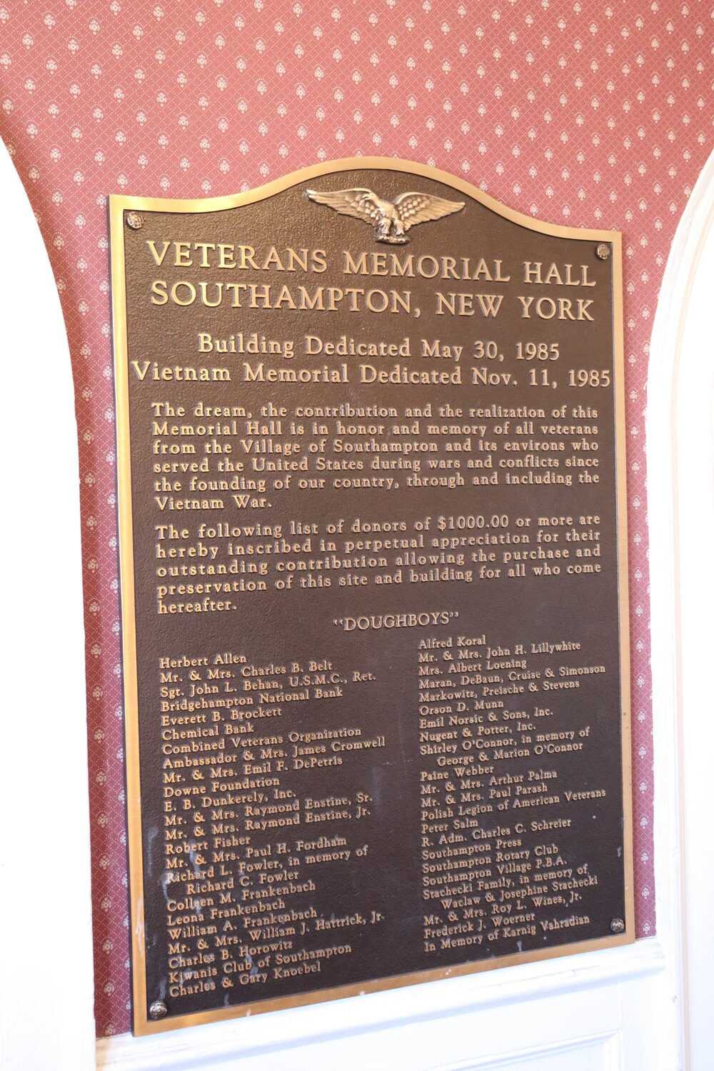 A plaque near the entrance of Veterans Hall in Southampton Village commemorates the individuals and groups that donated $1,000 or more to purchase the builder decades ago so it would remain in village hands. CAILIN RILEY