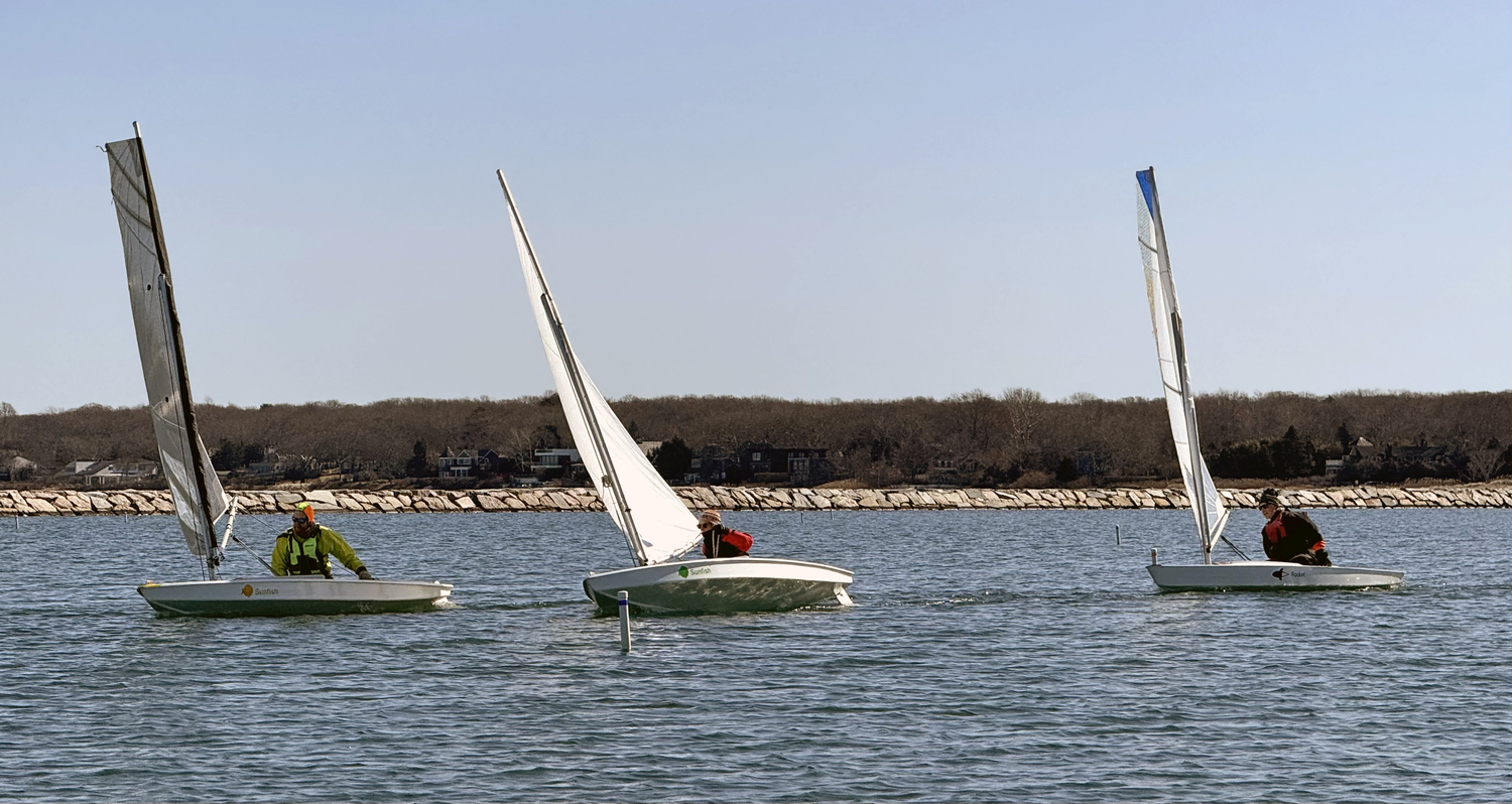 Mark Webber, left, heading for first place in the third race, while Joan Butler and the Breakwater Yacht Club's Commodore Nick Gazzolo after rounding the gybe mark and heading for the finish line.  MICHAEL MELLA