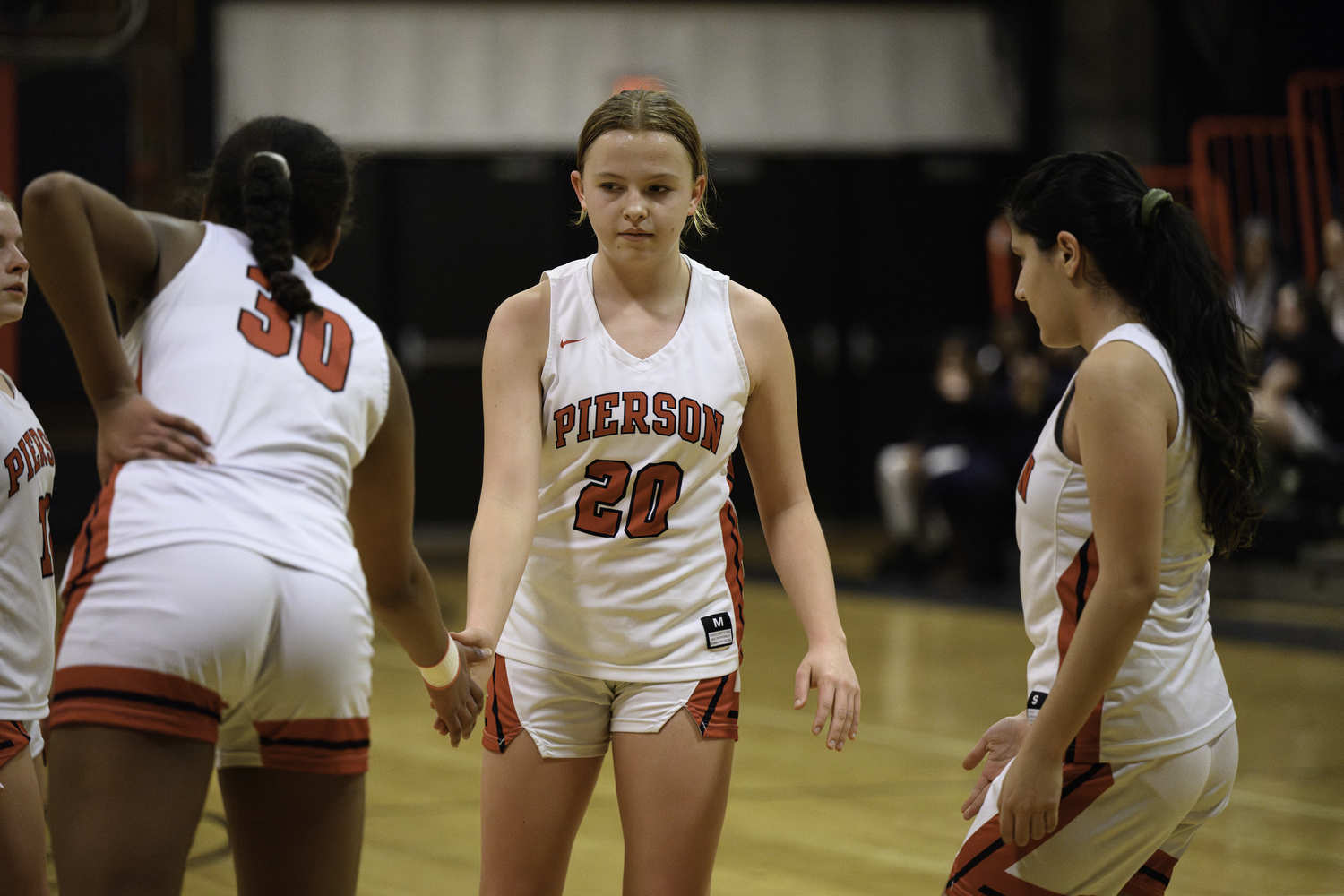 Skye Smith is congratulated by teammates after making a free throw.   MARIANNE BARNETT