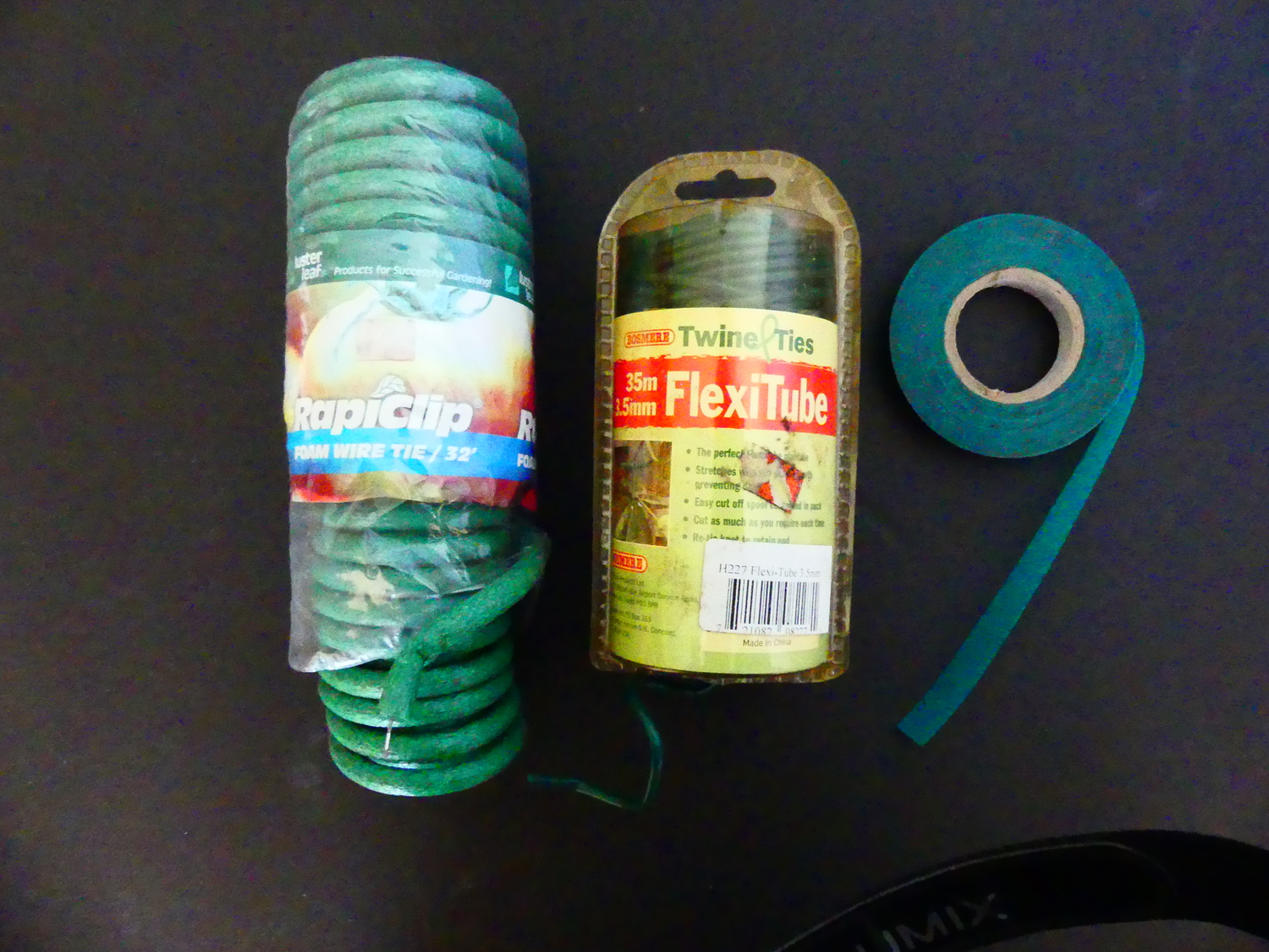 Of the many ways to tie a tomato plant, these three stand out. The foam-covered wire on the left can be cut to size and easily manipulated as needed. The same is true of the Flexitube tie  (center) but it’s thinner and can result in broken stems in heavy wind. On the right is a roll of thin vinyl tape that can be easily tied and wrapped without damaging branches and stems.  Half-inch-wide tape is shown here, and there is a 1-inch wide tape as well. Pieces of all three can and should be collected at the end of the season as all are reusable for several seasons.  ANDREW MESSINGER