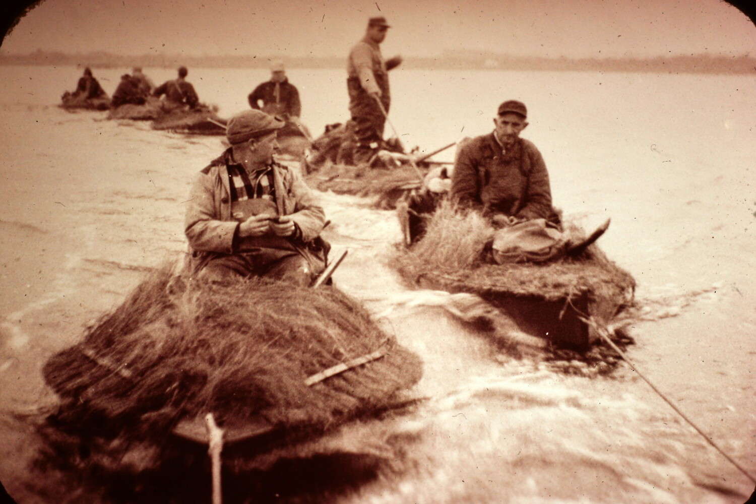 A platoon of scooters. Members of the Pattersquash Gunners Association are towed out into Bellport Bay decades ago. The 100-year-old club and the bountiful store of antique hunting gear its members have will be the spotlight subject of the 52nd Long Island Decoy Collector Association Show on March 2 in Hauppauge.