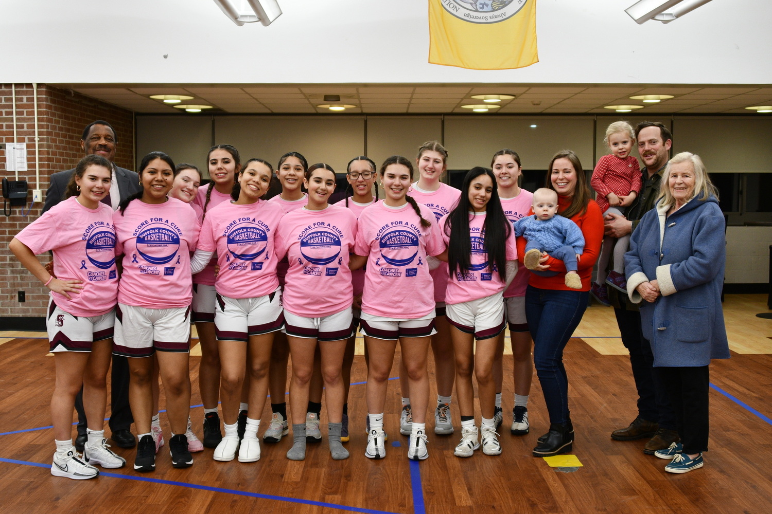 Brock Digger McMahon and his family with members of the Southampton girls basketball team. MICHELLE MALONE