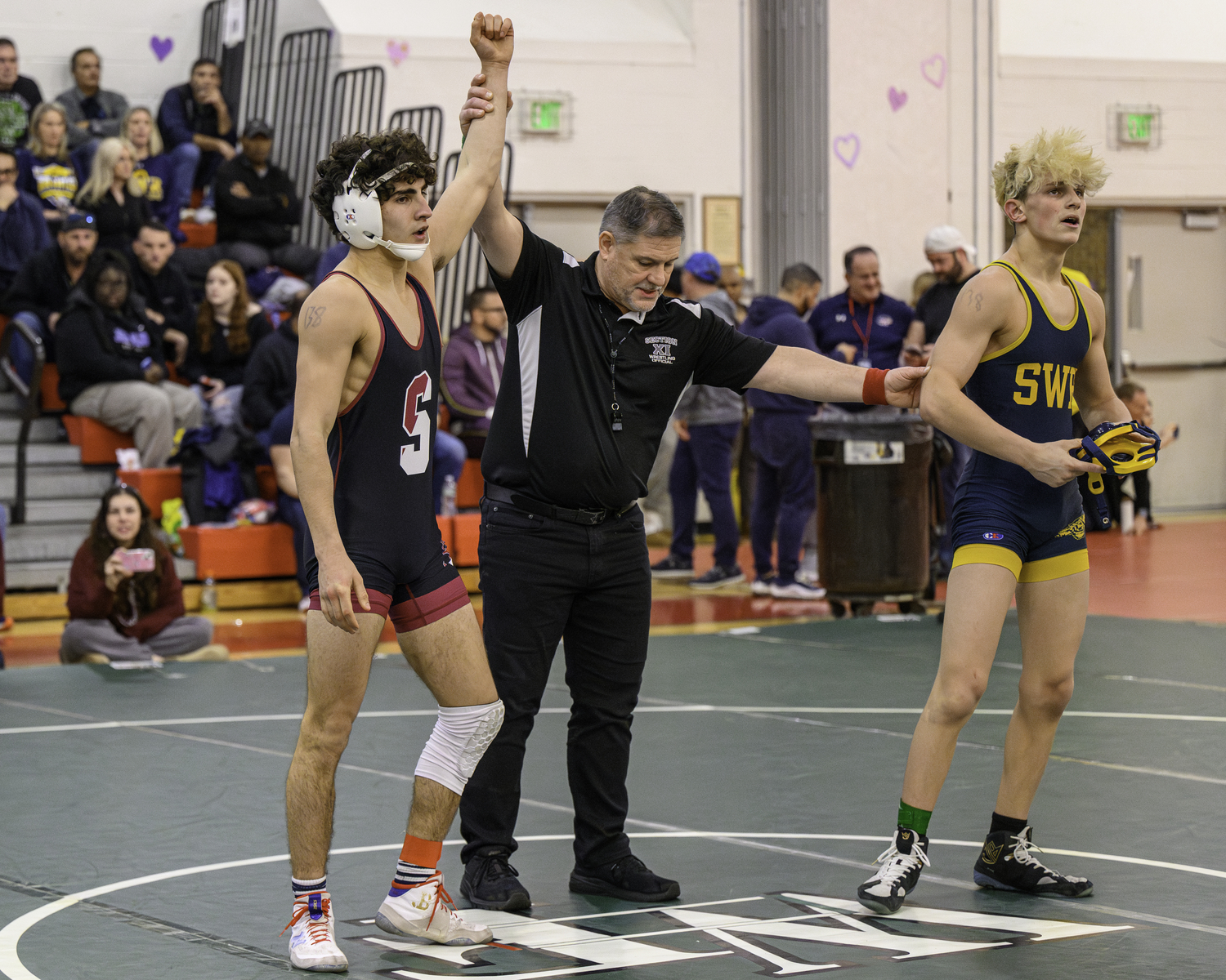 Jack Nastri gets his arm raised after defeating Shoreham-Wading River's Jacob Conti in the semifinals to place third.   MARIANNE BARNETT