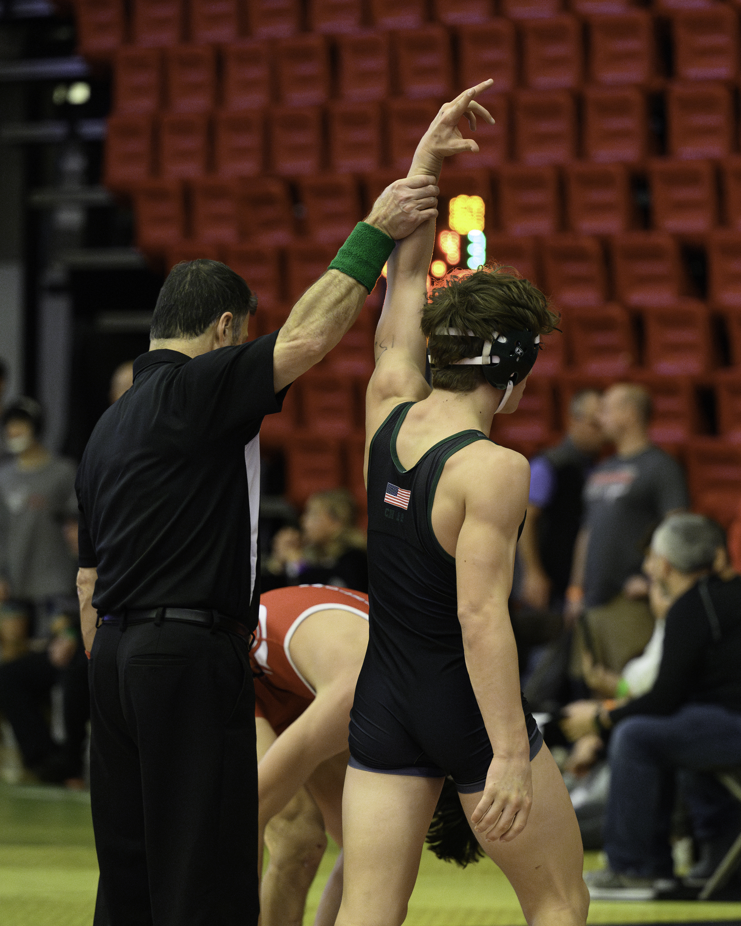 Hurricane Andrew Lewis gets his arm raised after winning his opening-round match.   MARIANNE BARNETT