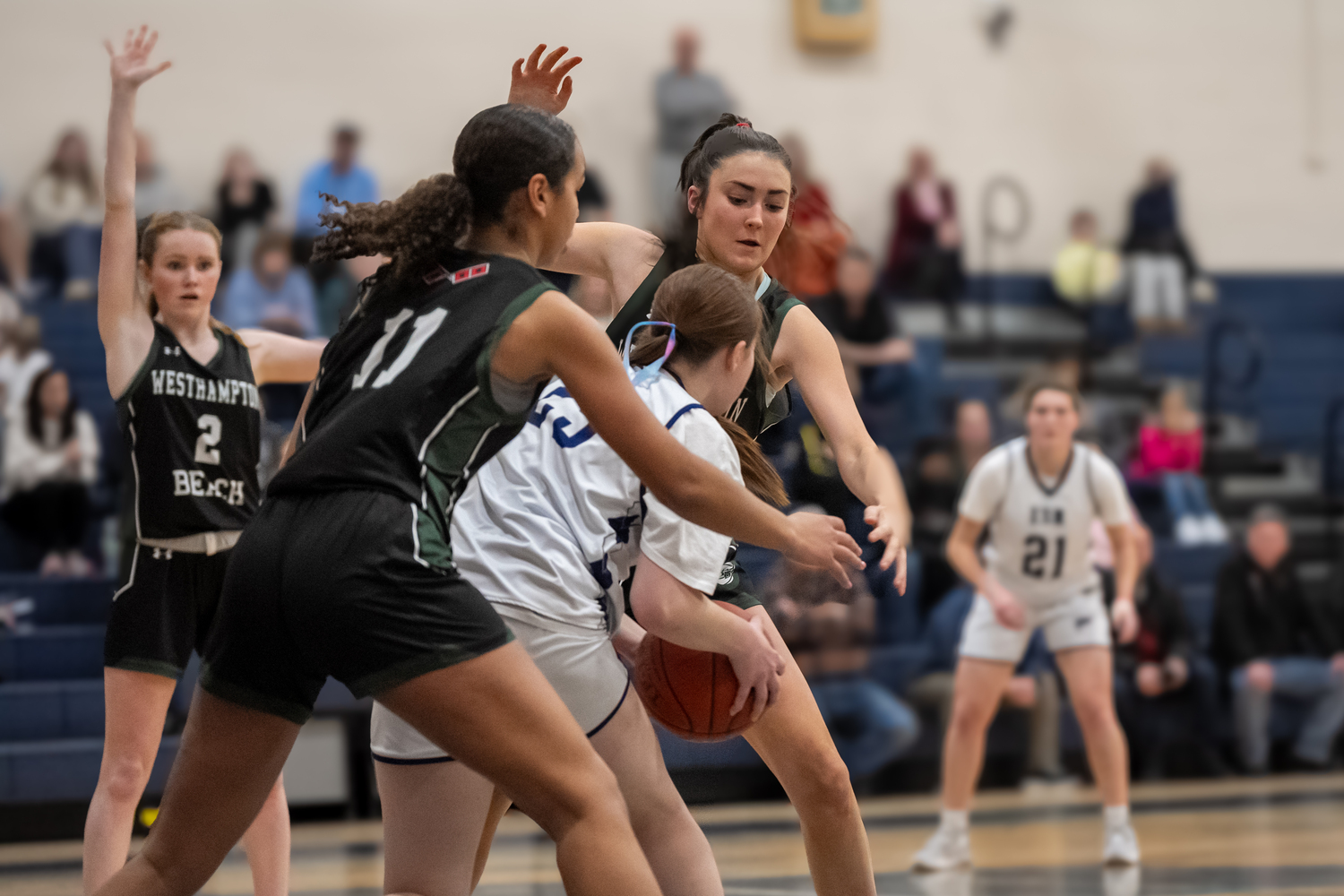 Sophomore Jasmine Taylor and eighth-grader Chloe Blowes swarm an opponent. RON ESPOSITO