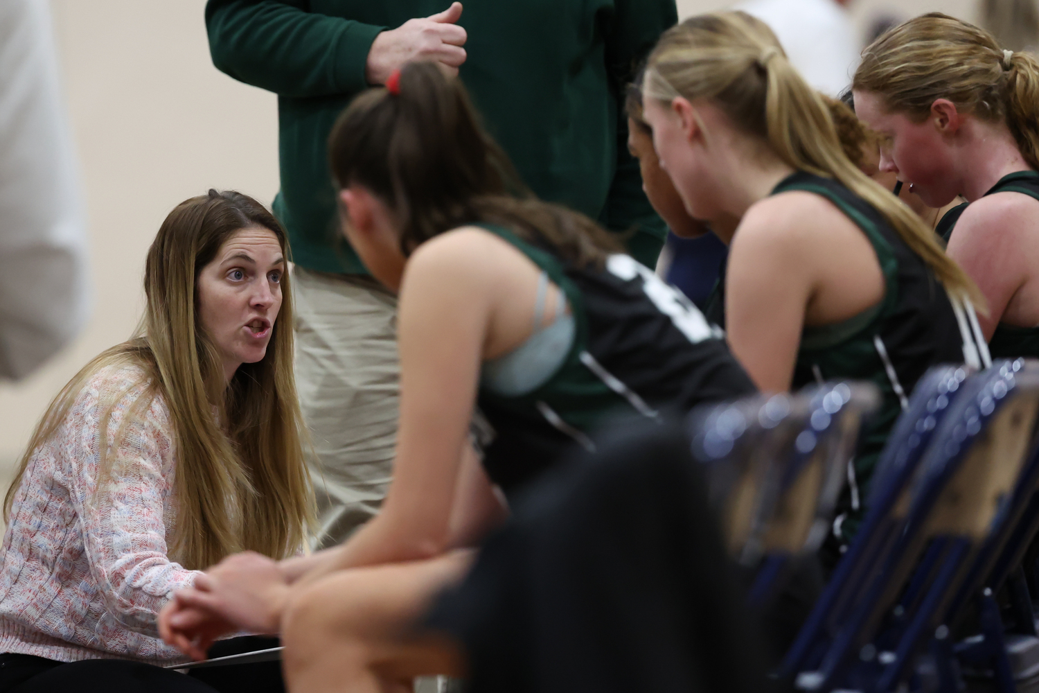 Head coach Katie Peters talks to her starters during a timeout. RON ESPOSITO