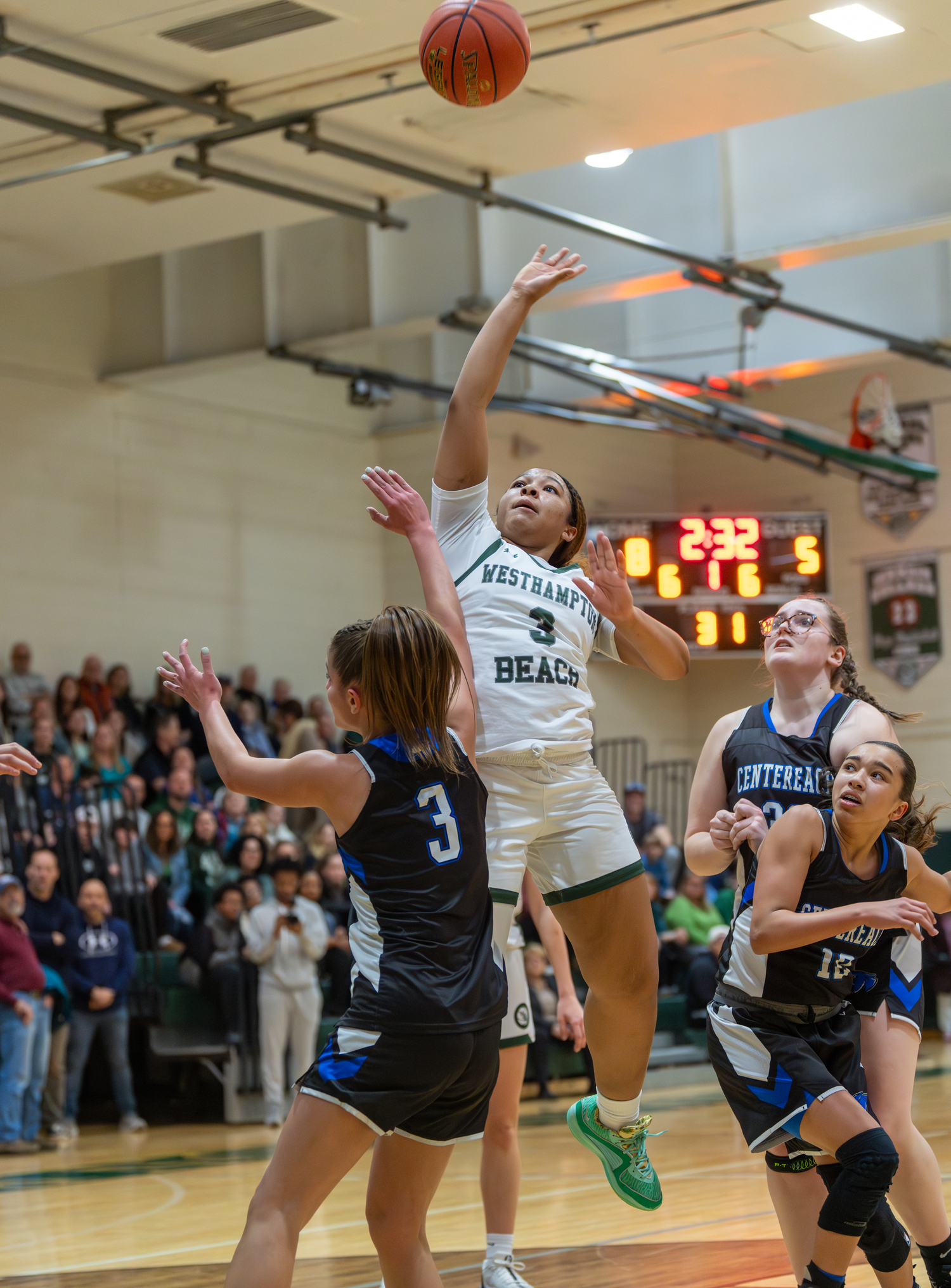 Westhampton Beach sophomore Sandra Clarke floats a shot up in the air.   RON ESPOSITO