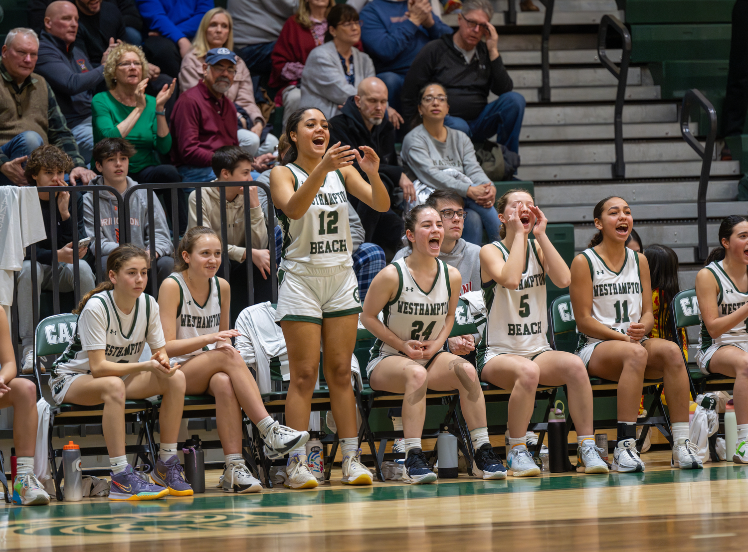 Westhampton Beach senior Zoe Stokes leads the cheers for her team on the court.    RON ESPOSITO
