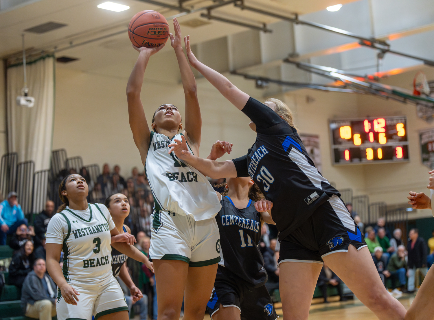 Westhampton Beach sophomore Jasmine Taylor is fouled going up for a shot. She scored eight points and had five rebounds, all on the offensive end of the court.   RON ESPOSITO